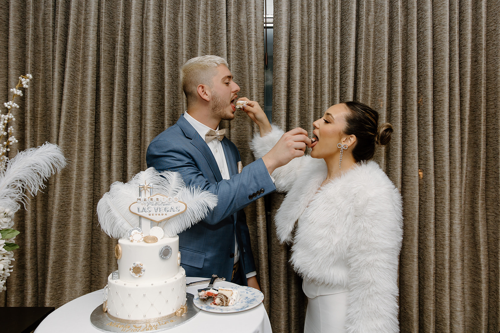 Bride and groom feed each other cake
