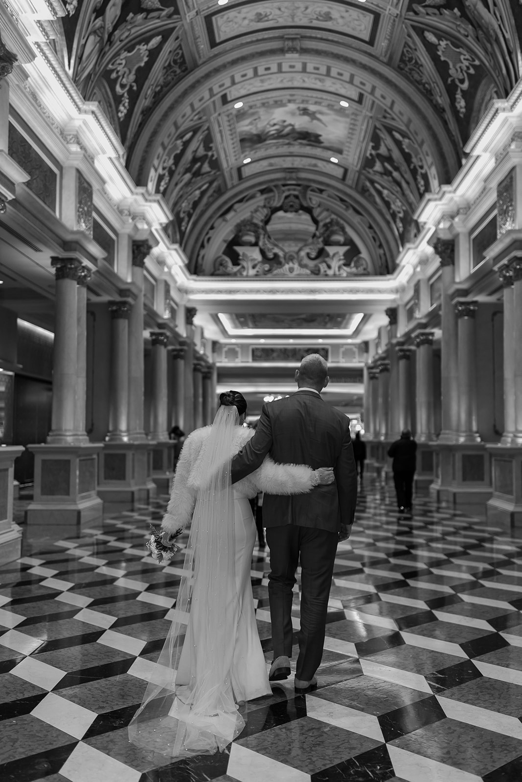 Bride and groom walk through a hallway in the Venetian hotel