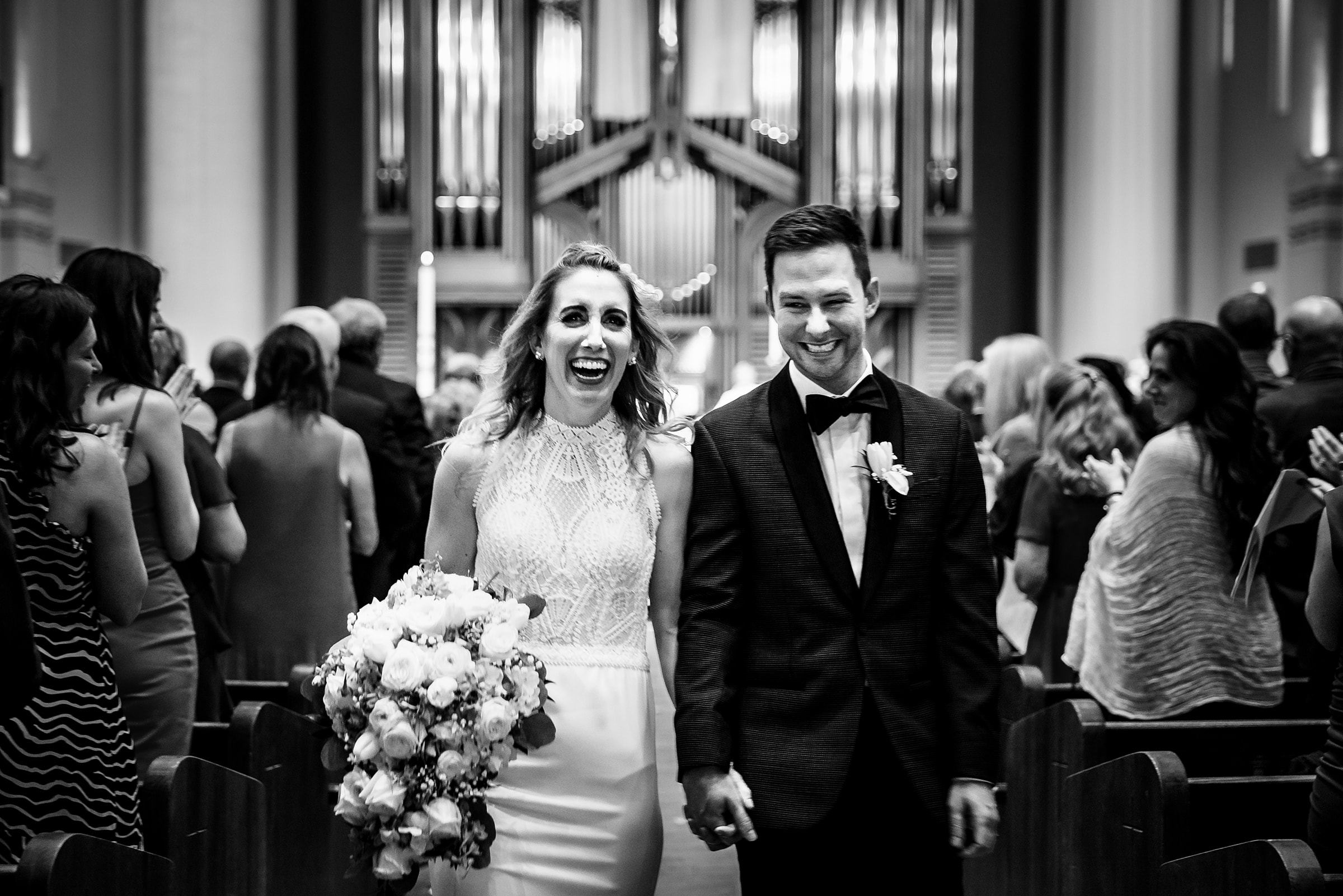 Newly married wedding couple walk down the aisle after their church ceremony in Cincinnati, OH