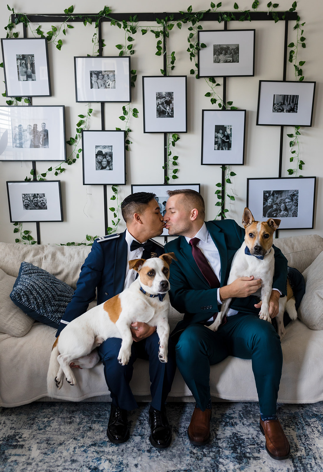 Two grooms give each other a kiss in their living room ahead of their wedding day,..