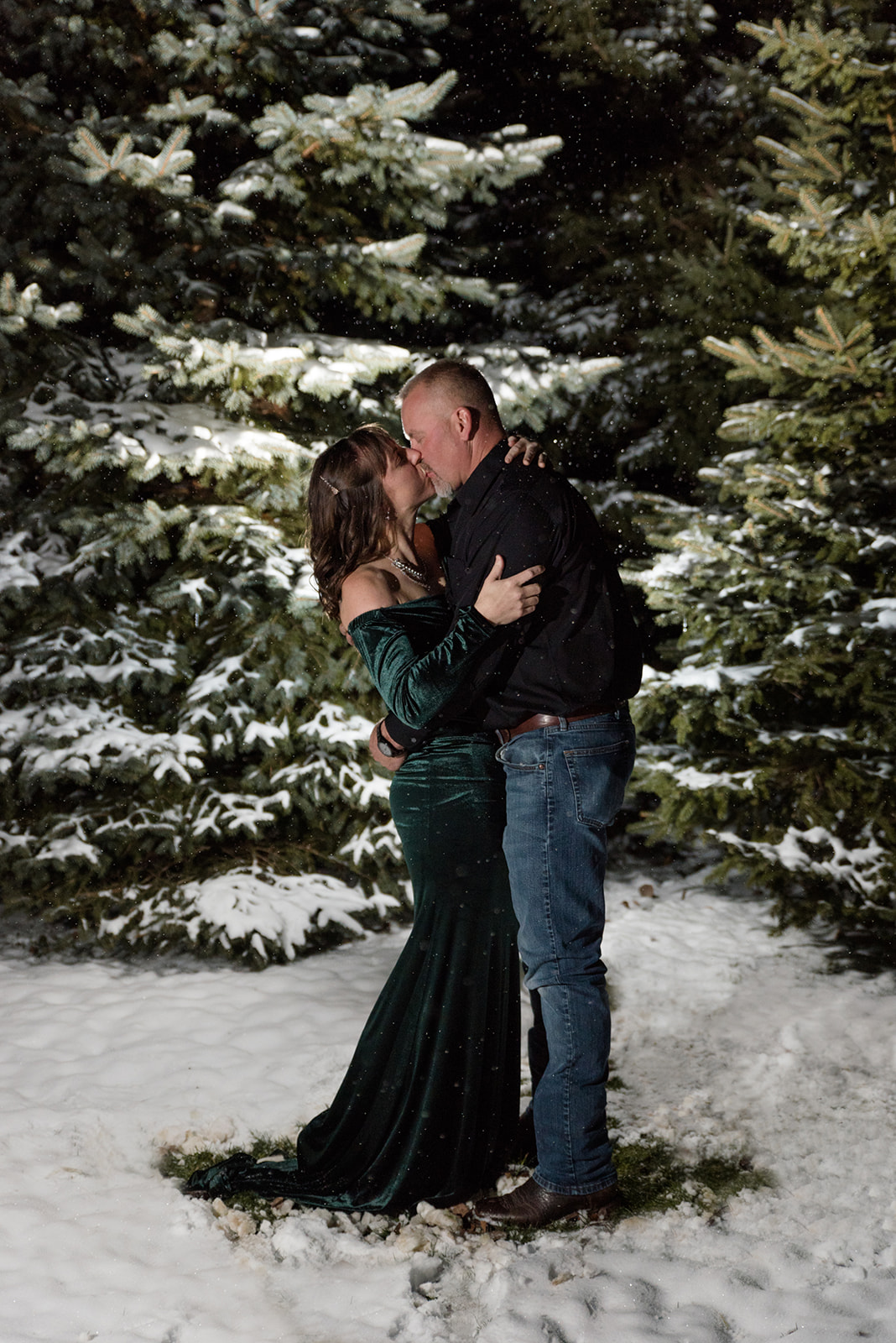 Husband and Wife kiss in the snowy night