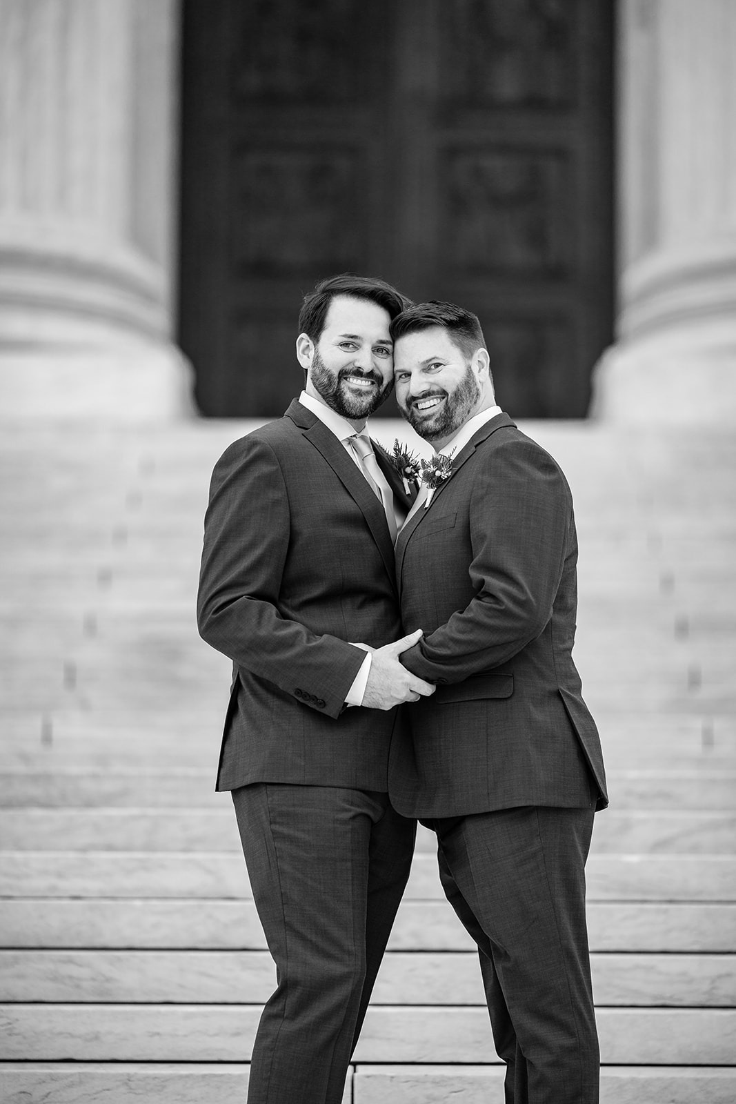 Black and white portrait of grooms outside Supreme Court