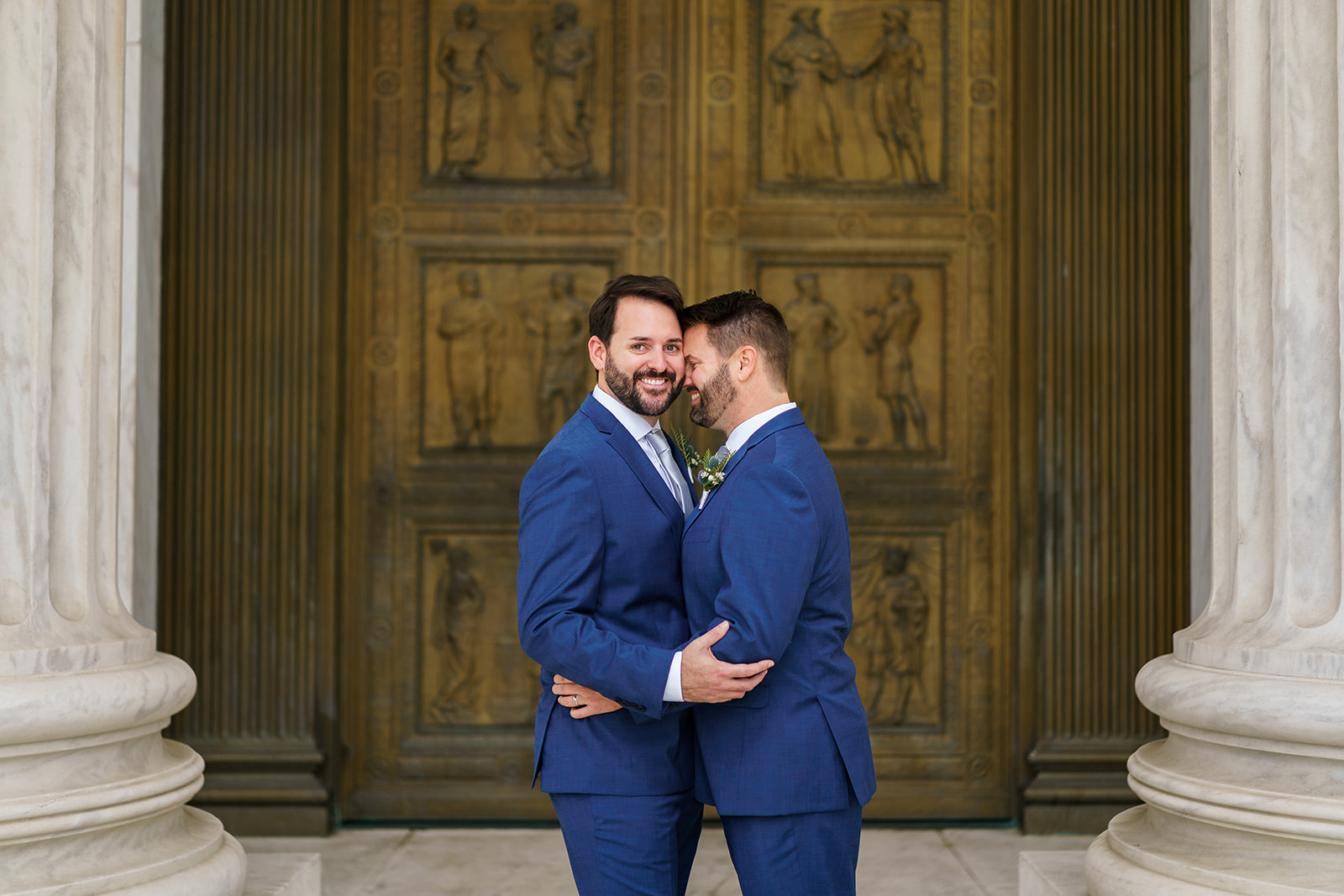 Same-sex couple in front of Supreme Court doors