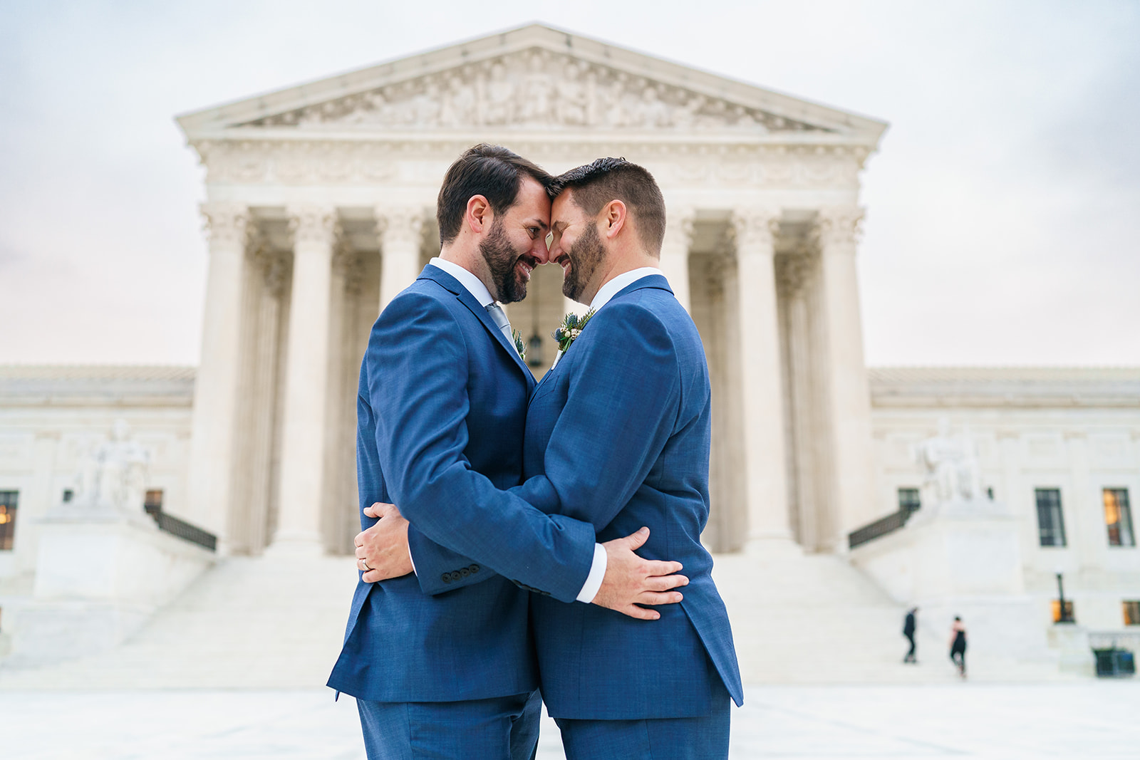 Couple embraces in front of Supreme Court