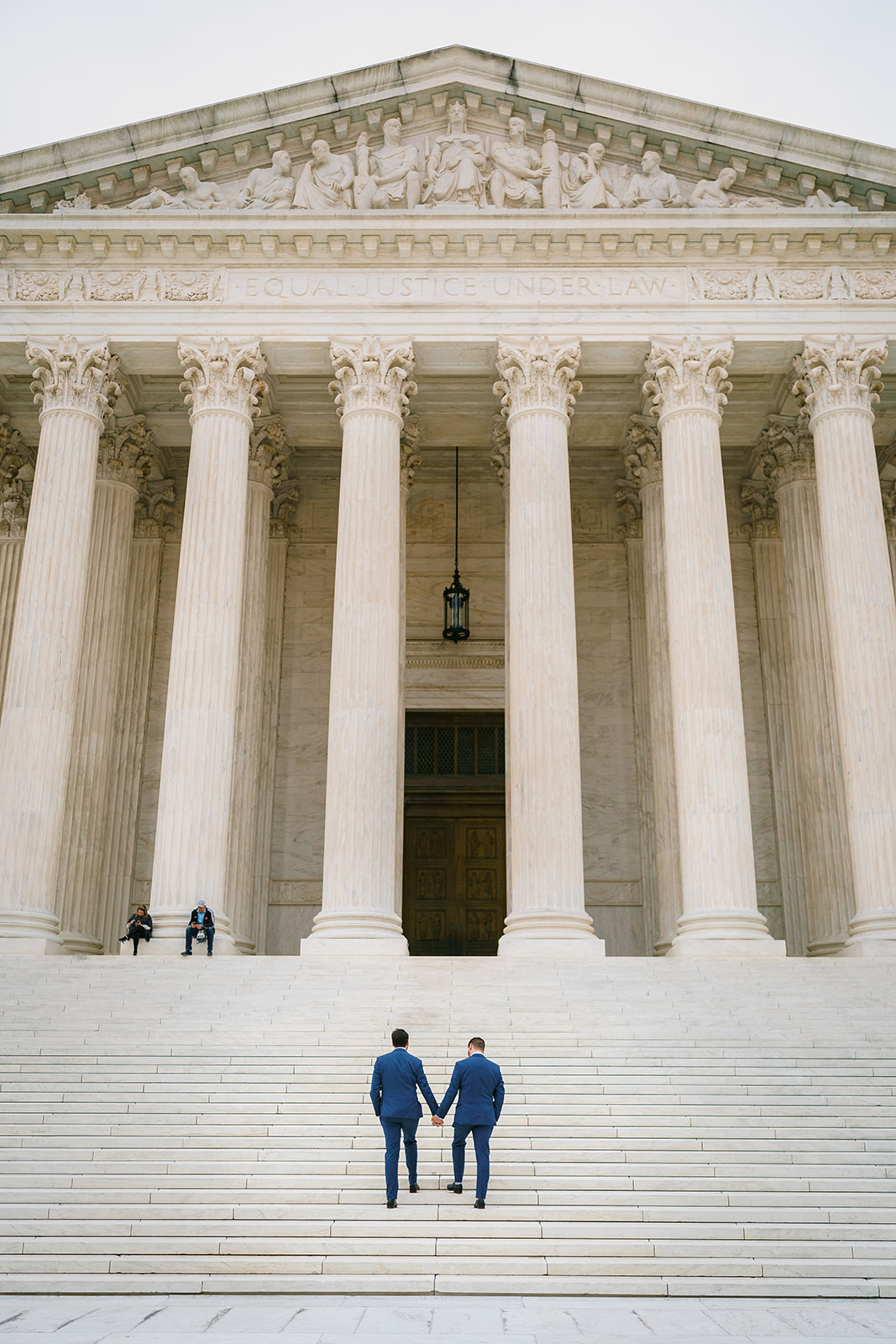 Wide-angle photo of wedding couple on Supreme Court steps