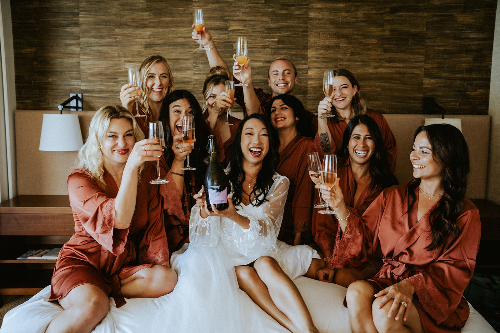Bridal party celebrating and enjoying some champagne with the bride before the ceremony