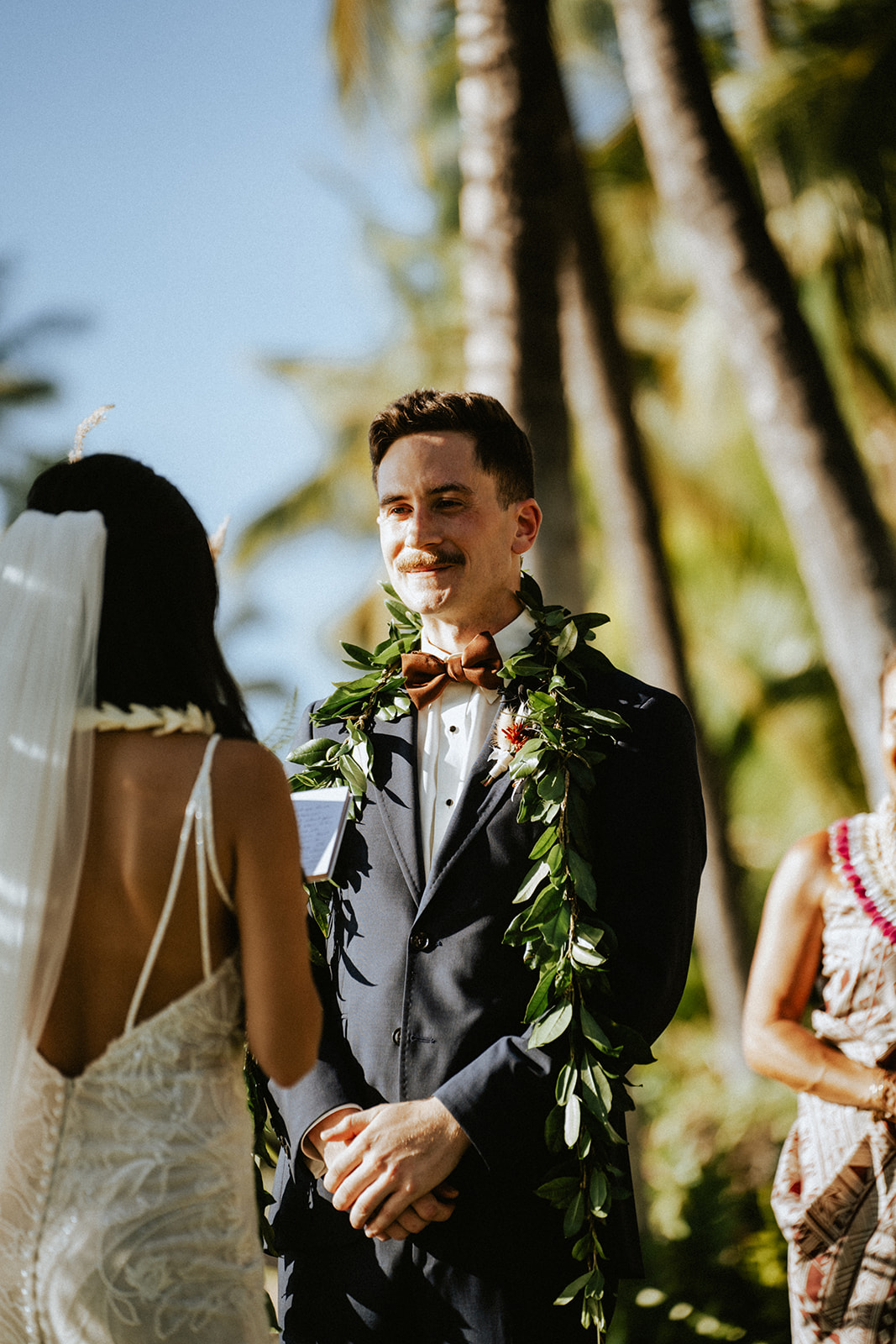 Bride and groom recite their vows at Lanikuhonua on a sunny day