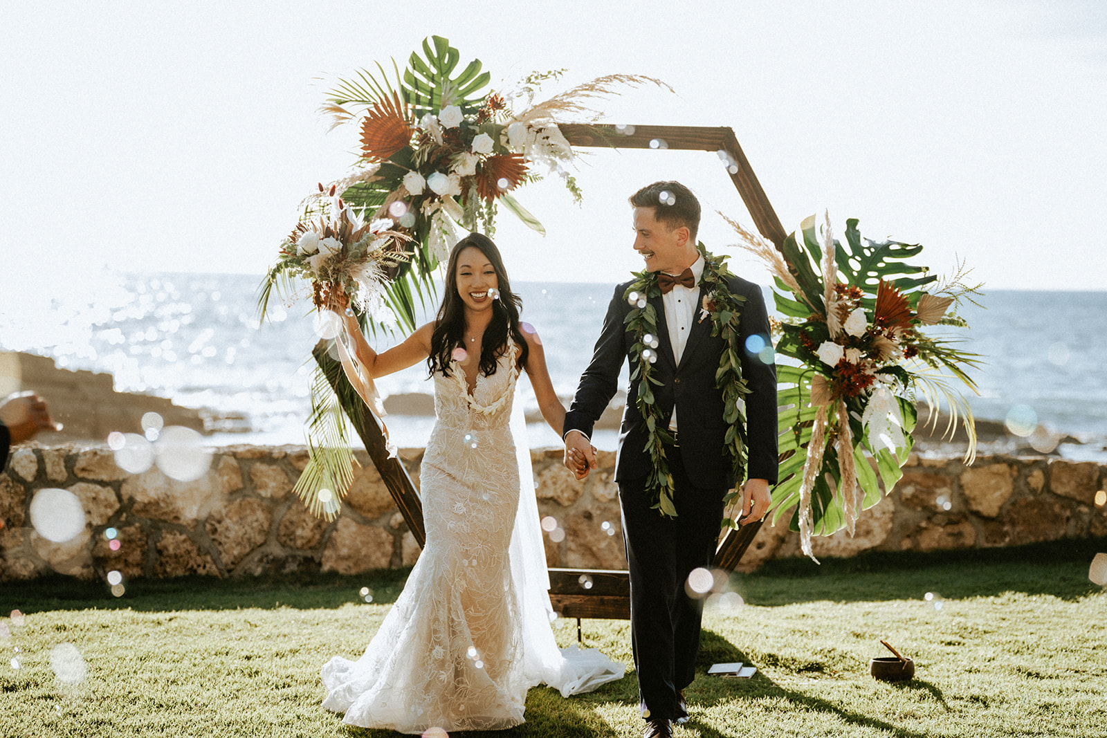 Bride and groom bubble send off at Lanikuhonua, Hawaii on a sunny day