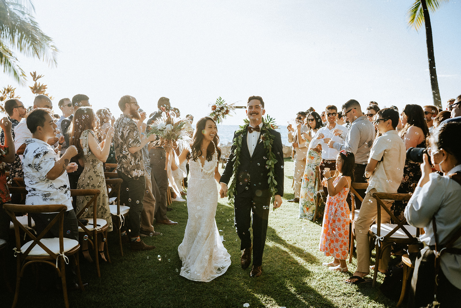 Bride and groom bubble send off at Lanikuhonua, Hawaii on a sunny day