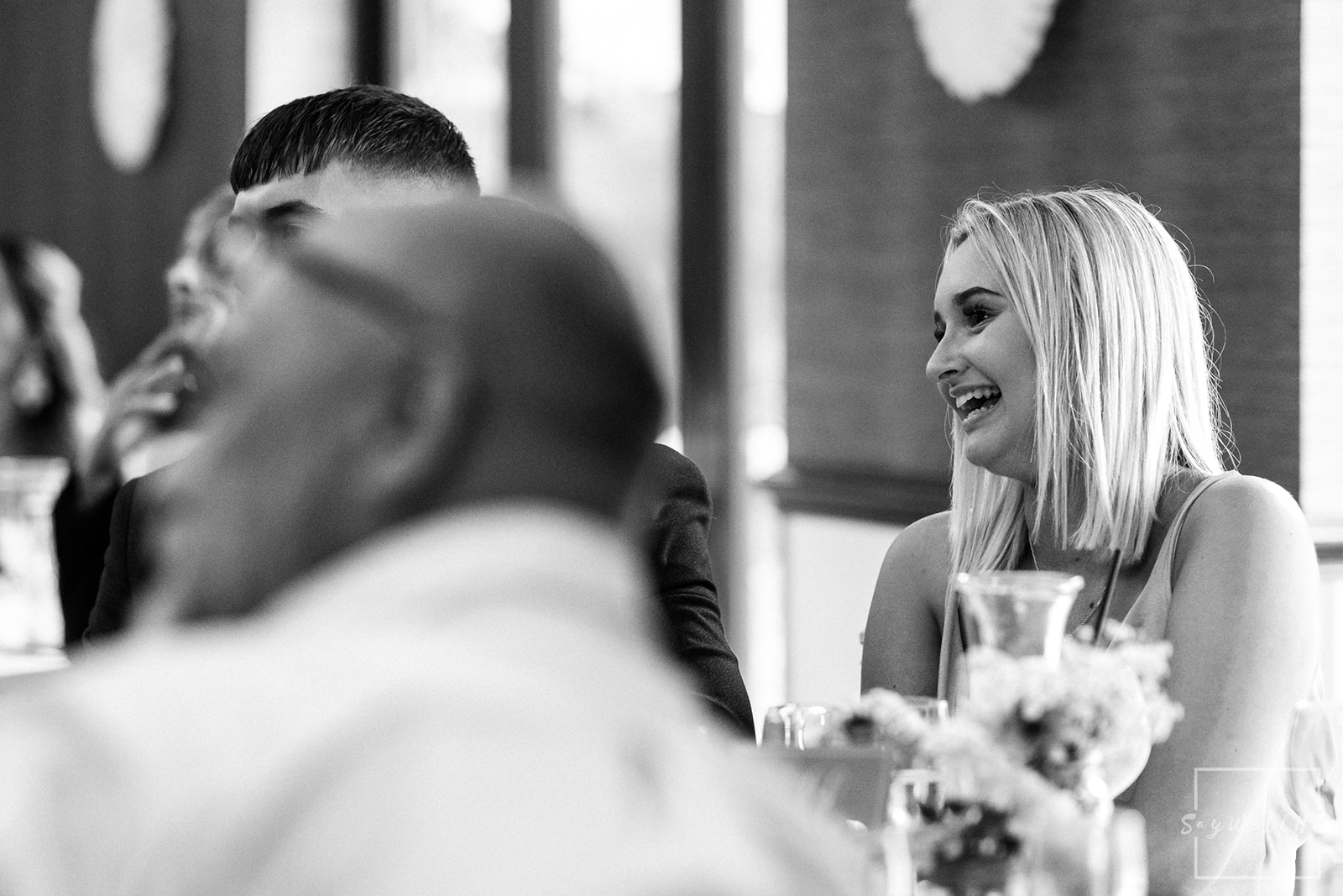 Sigma 85mm F1.4 DG DN | wedding guest smiling during the wedding speeches