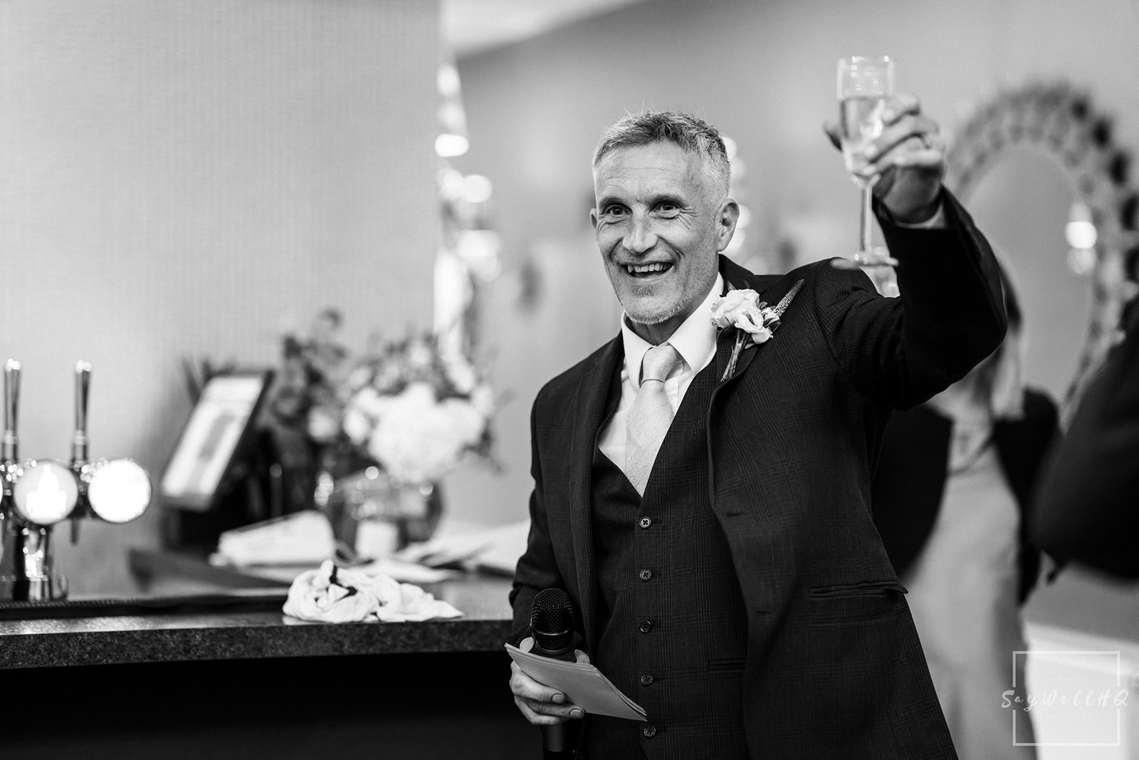 Sigma 85mm F1.4 DG DN | wedding guest raising a toast to the happy couple during  the speeches