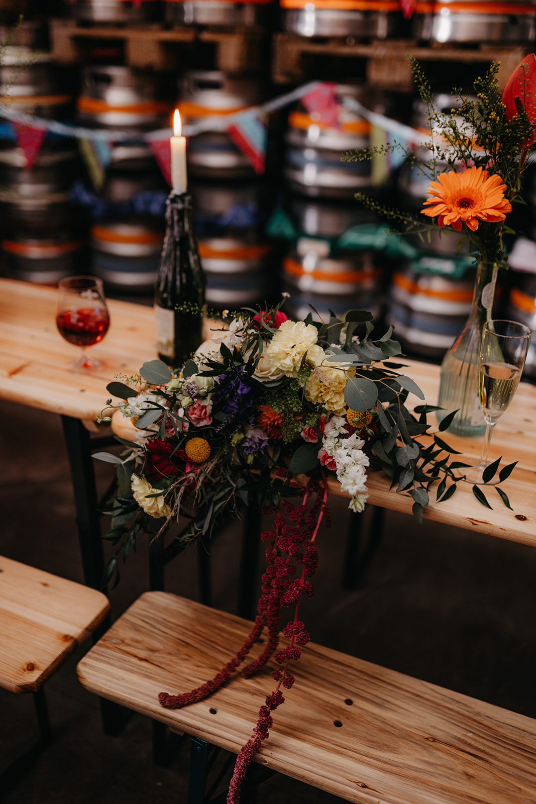 Bouquet sits on table surrounded by beer kegs at crossborders brewery taproom 