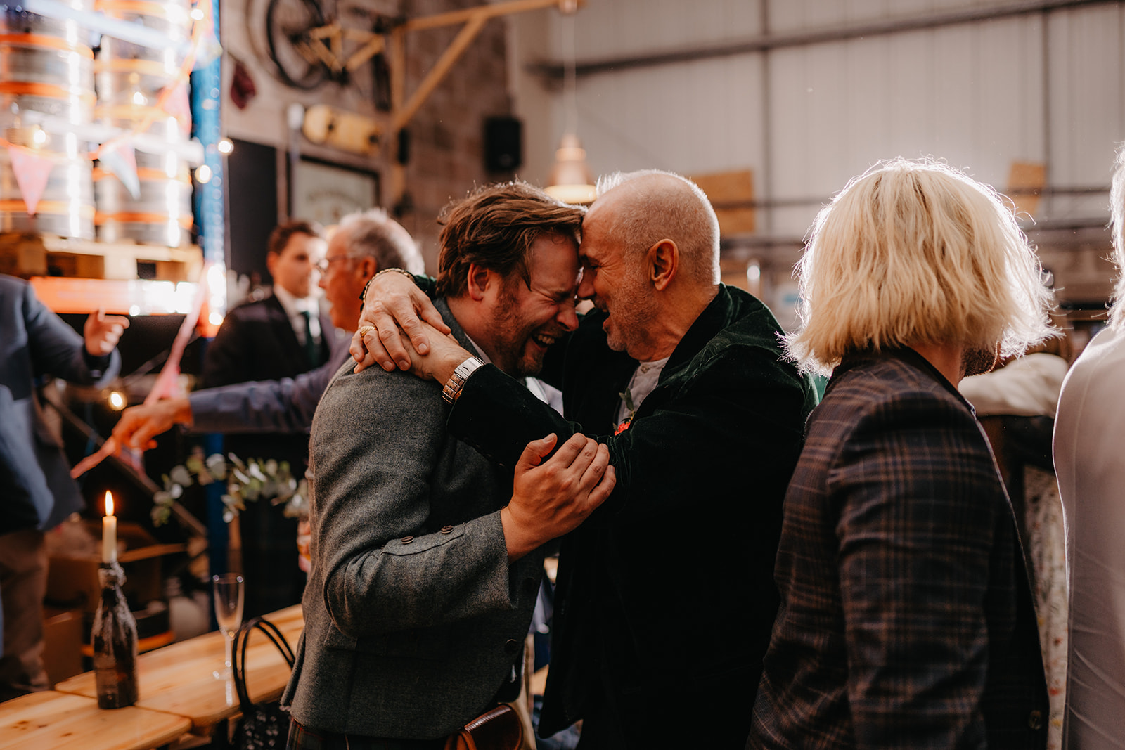 Groom and father have a fun moment at edinburgh wedding 