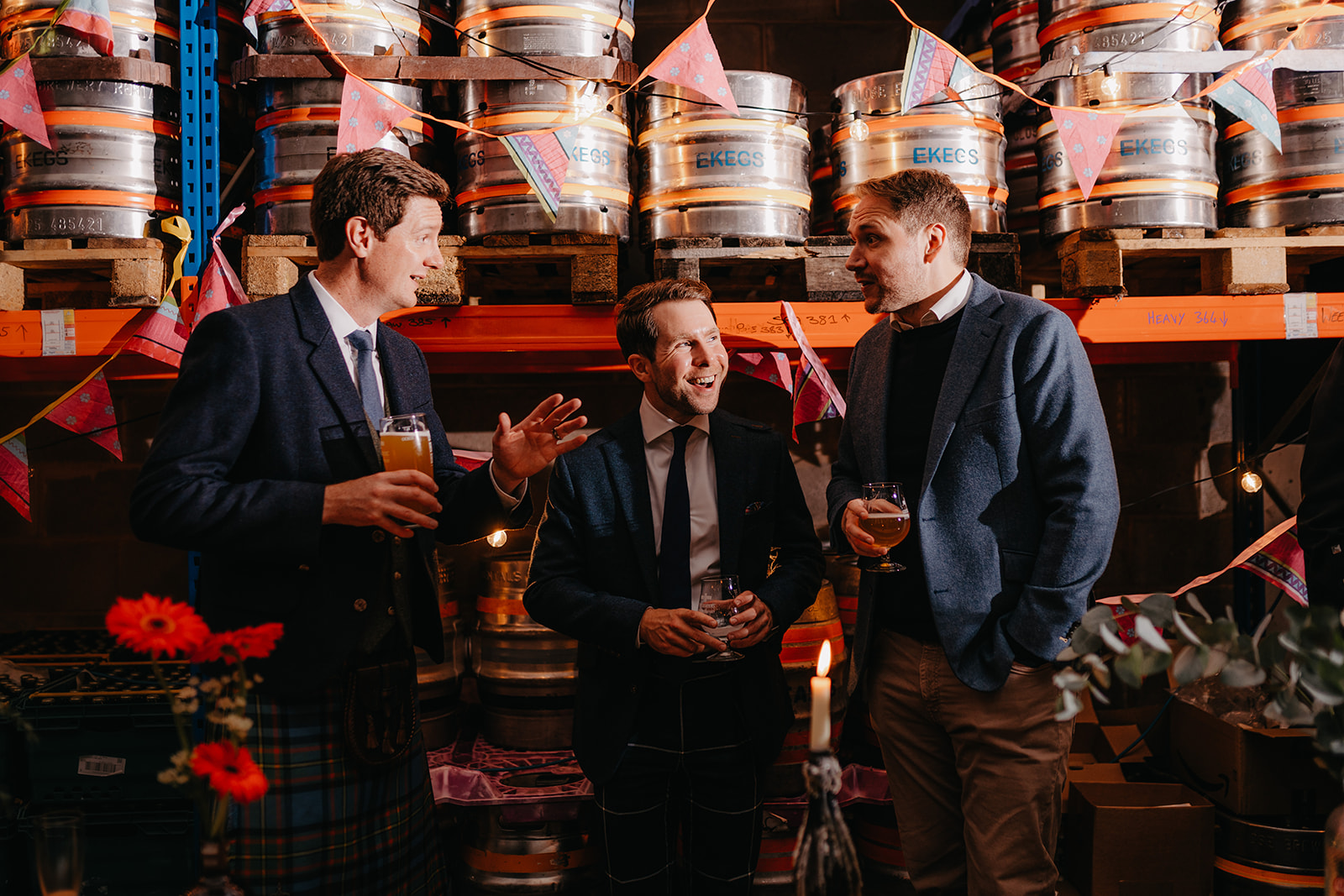 guests laugh and drink crossborders beers at taproom wedding reception in edinburgh