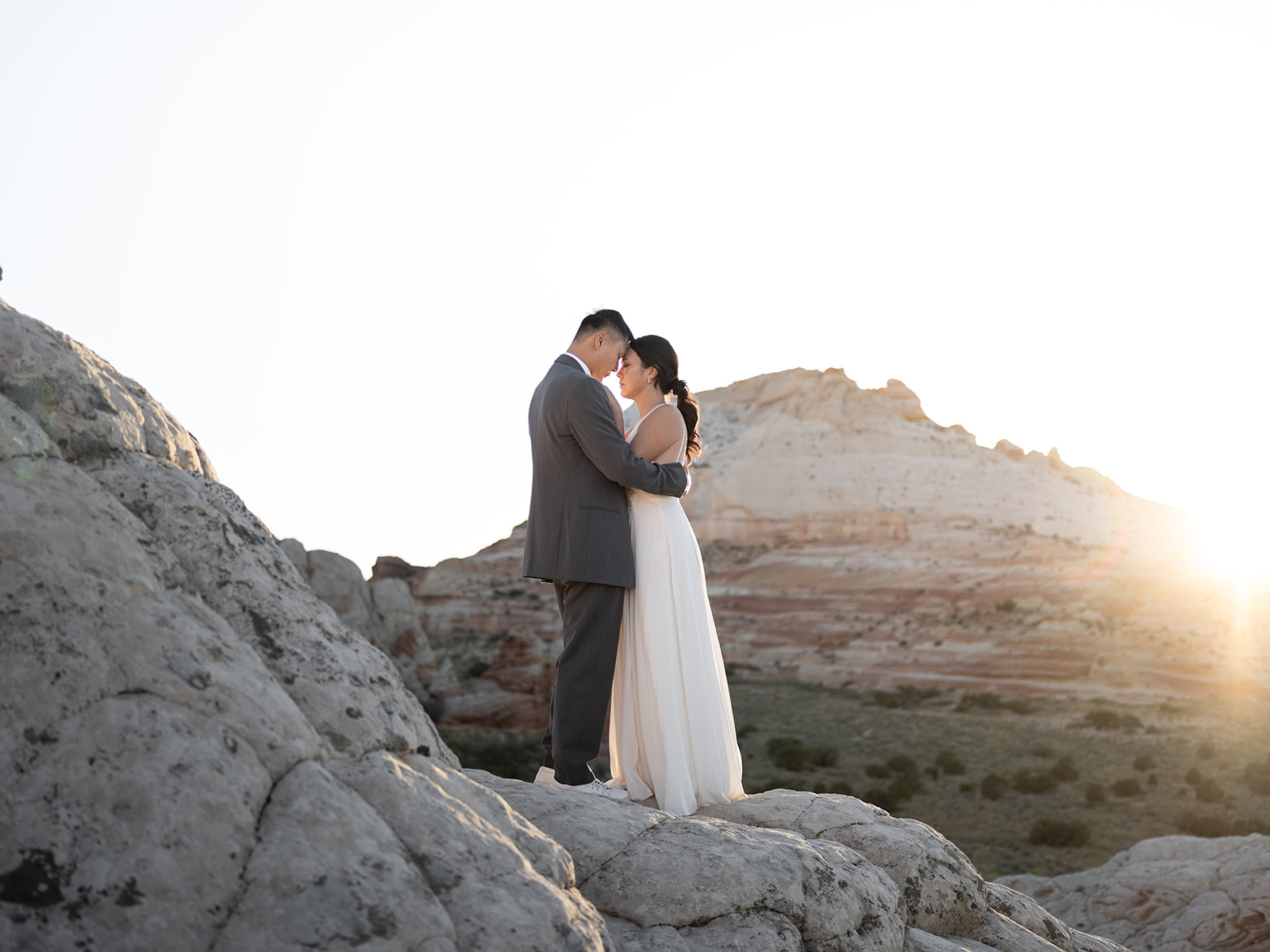 Couple exchanging vows at sunset during their elopement in the unique and otherworldly landscape of White Pocket