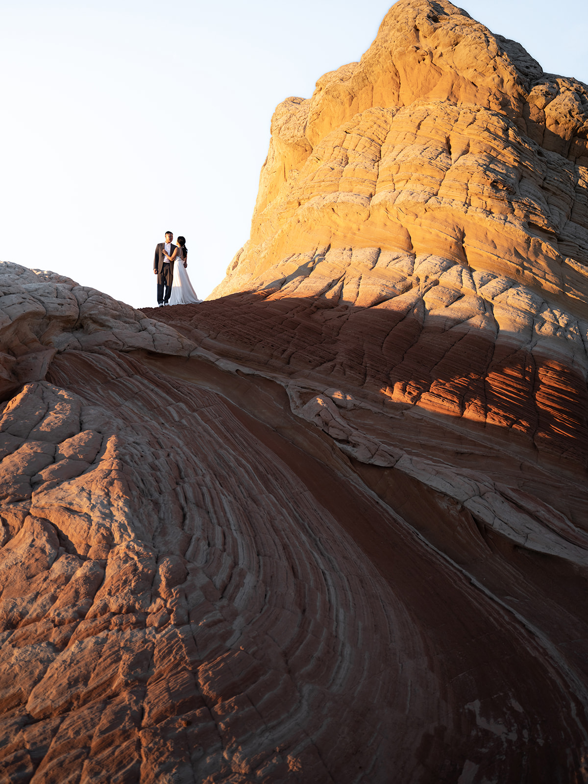 Couple celebrating their elopement surrounded by beautiful sandstone formations in White Pocket, Arizona