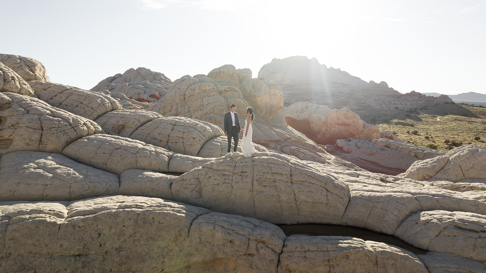 Intimate elopement ceremony surrounded by stunning sandstone formations in White Pocket, Arizona