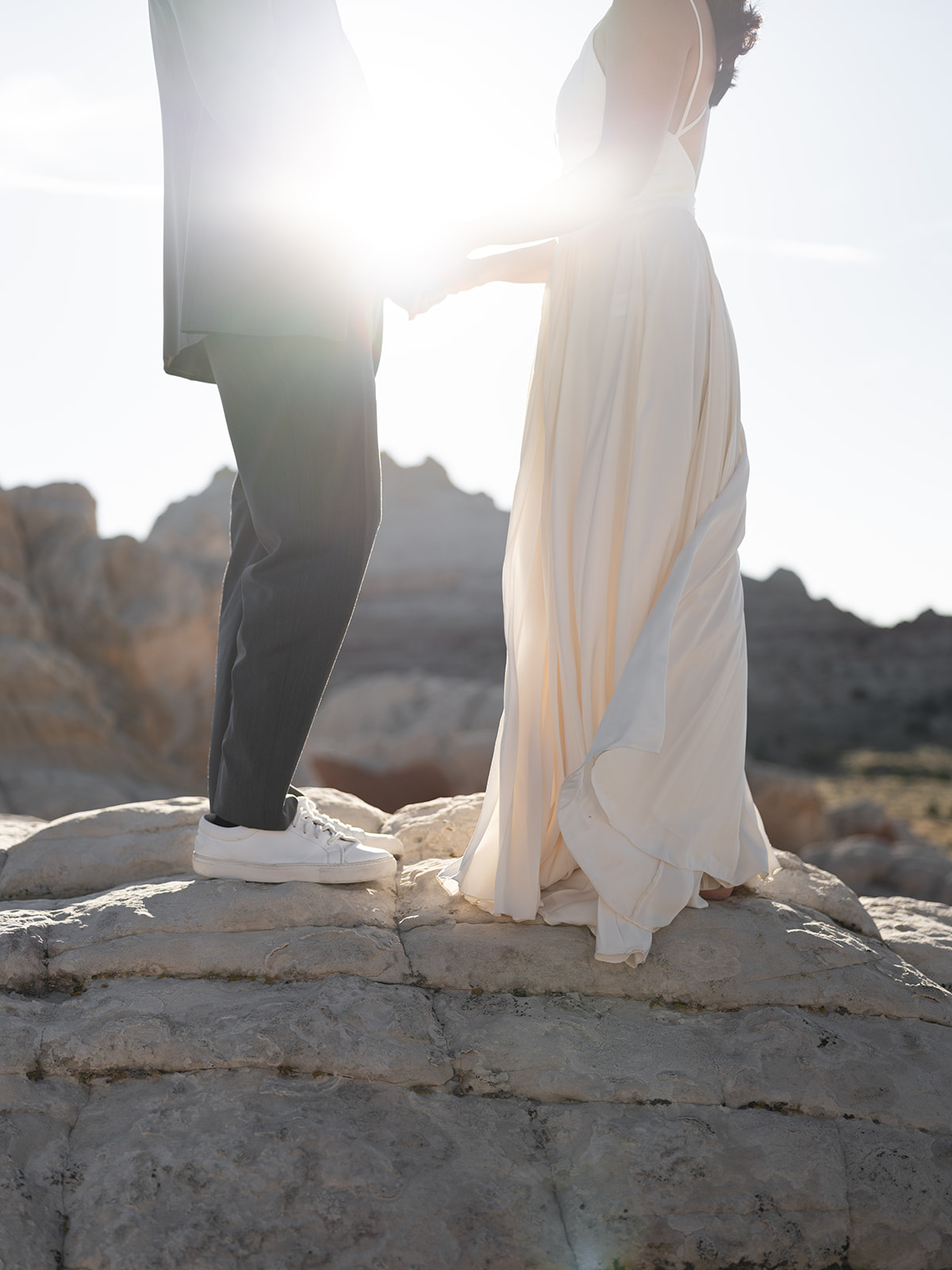 Couple exchanging vows at sunset during their elopement at White Pocket, Arizona