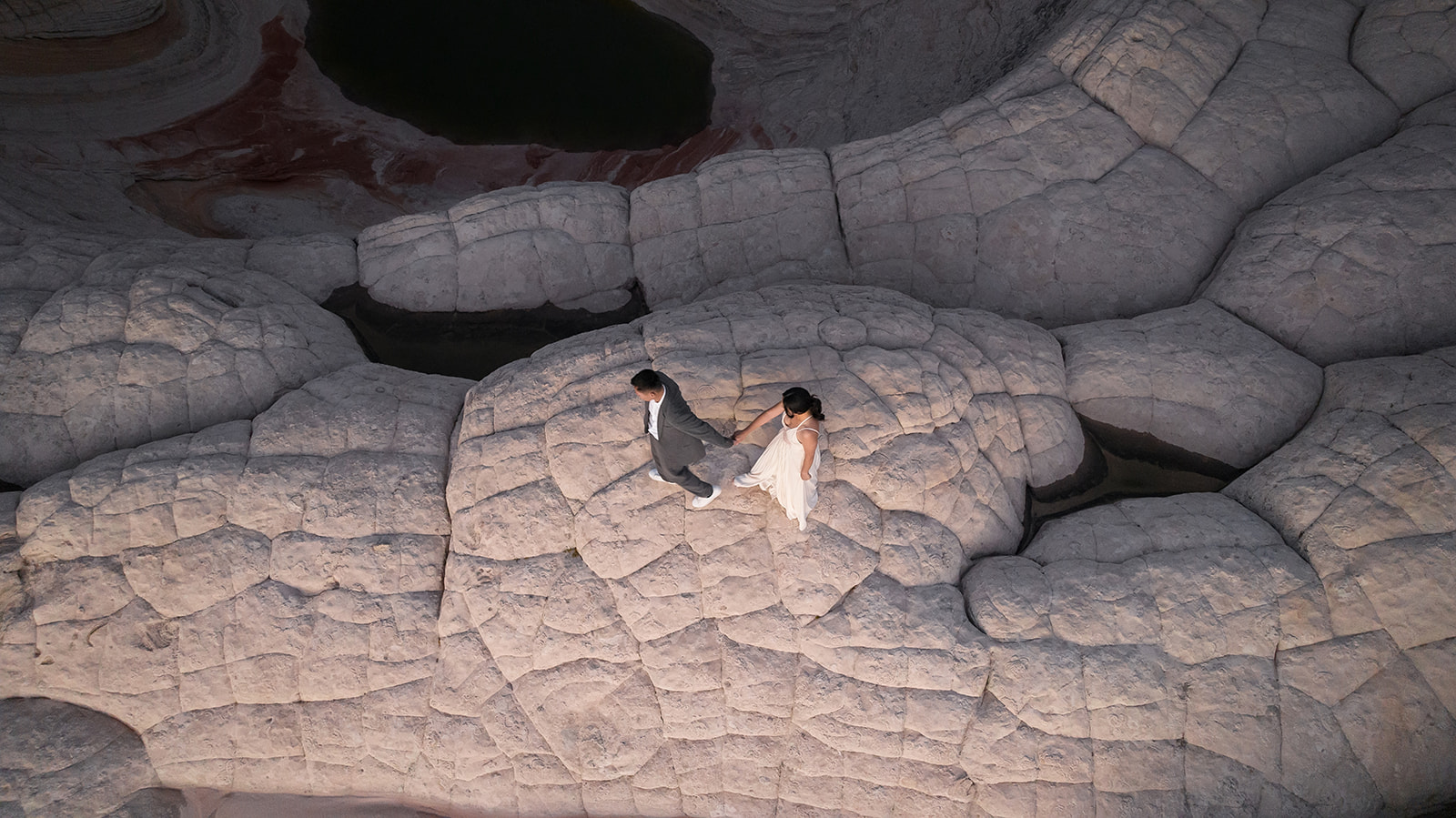 Drone Shot of a couple walking over domes in White Pocket Arizona during their Elopement 
