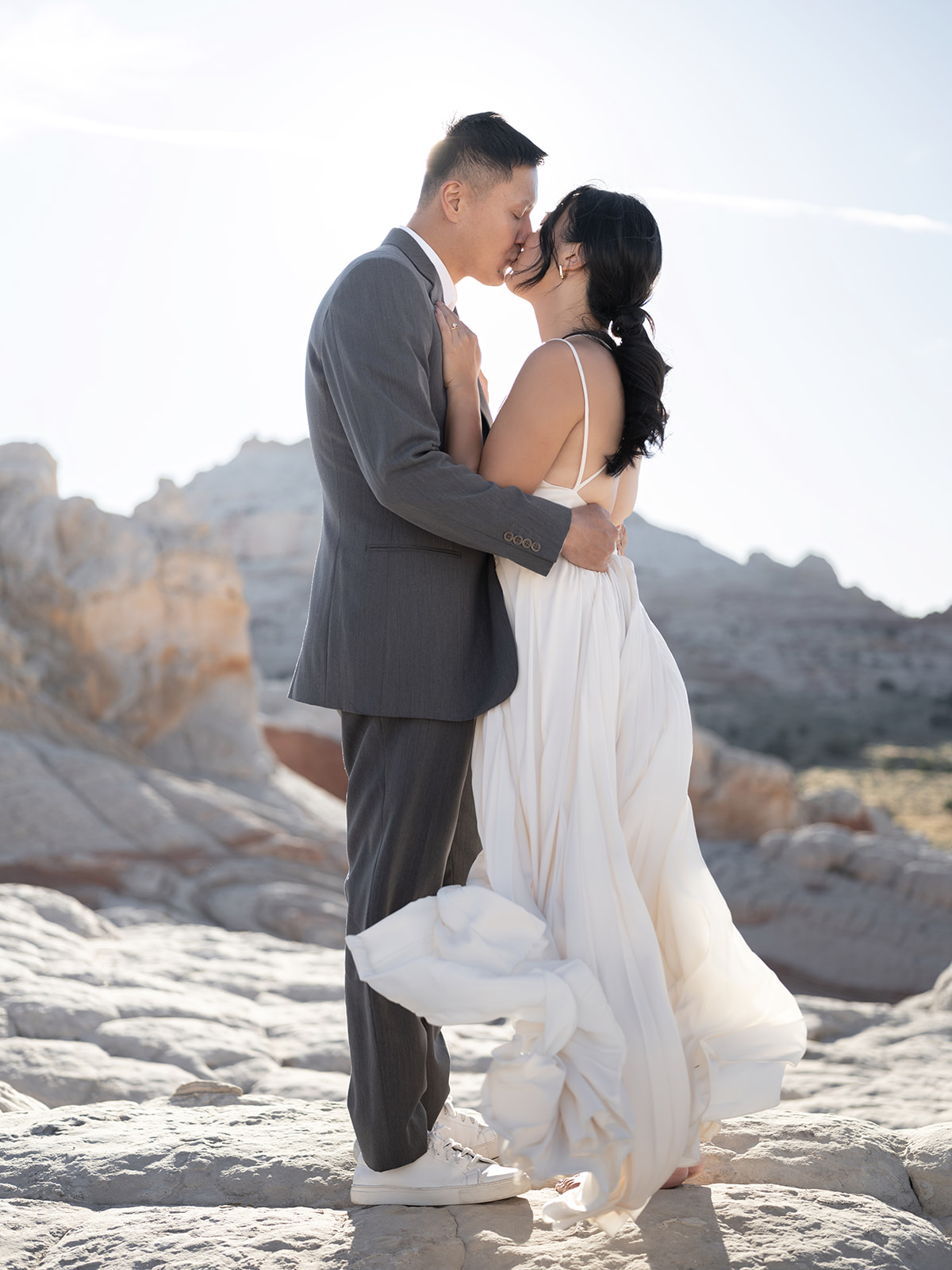 Couple celebrating their elopement surrounded by stunning rock formations in White Pocket, Arizona