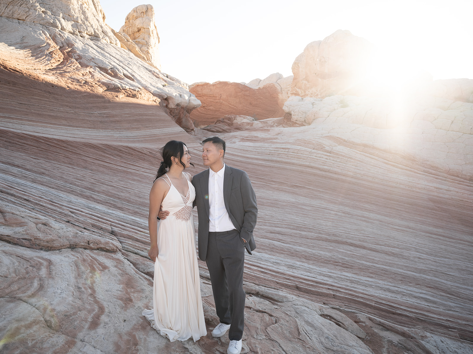Intimate elopement ceremony at White Pocket, Arizona with breathtaking sandstone formations in the background