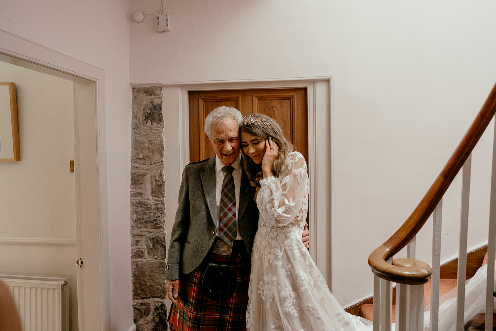 boho bride embraces with her dad after getting ready on her wedding morning.