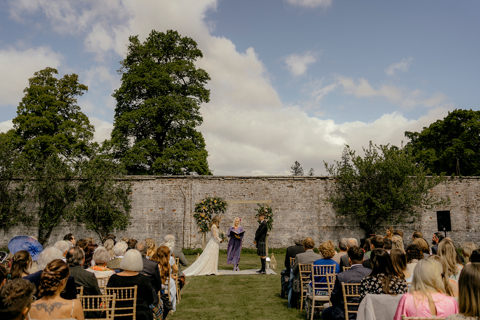 boho bride and groom have humanist wedding ceremony in belladrum walled garden