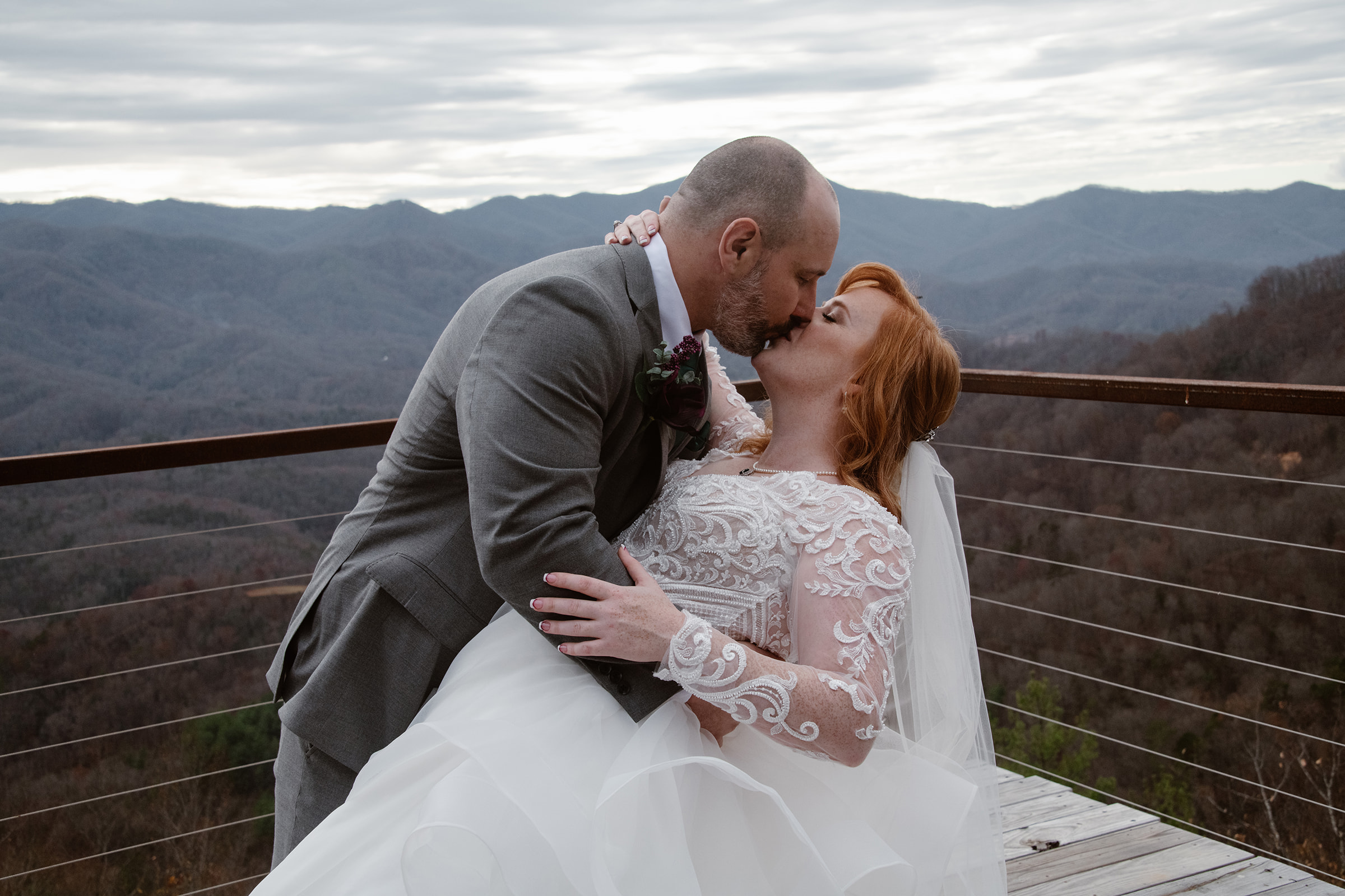 Couple share a passionate kiss overlooking the Blue Ridge Mountains.