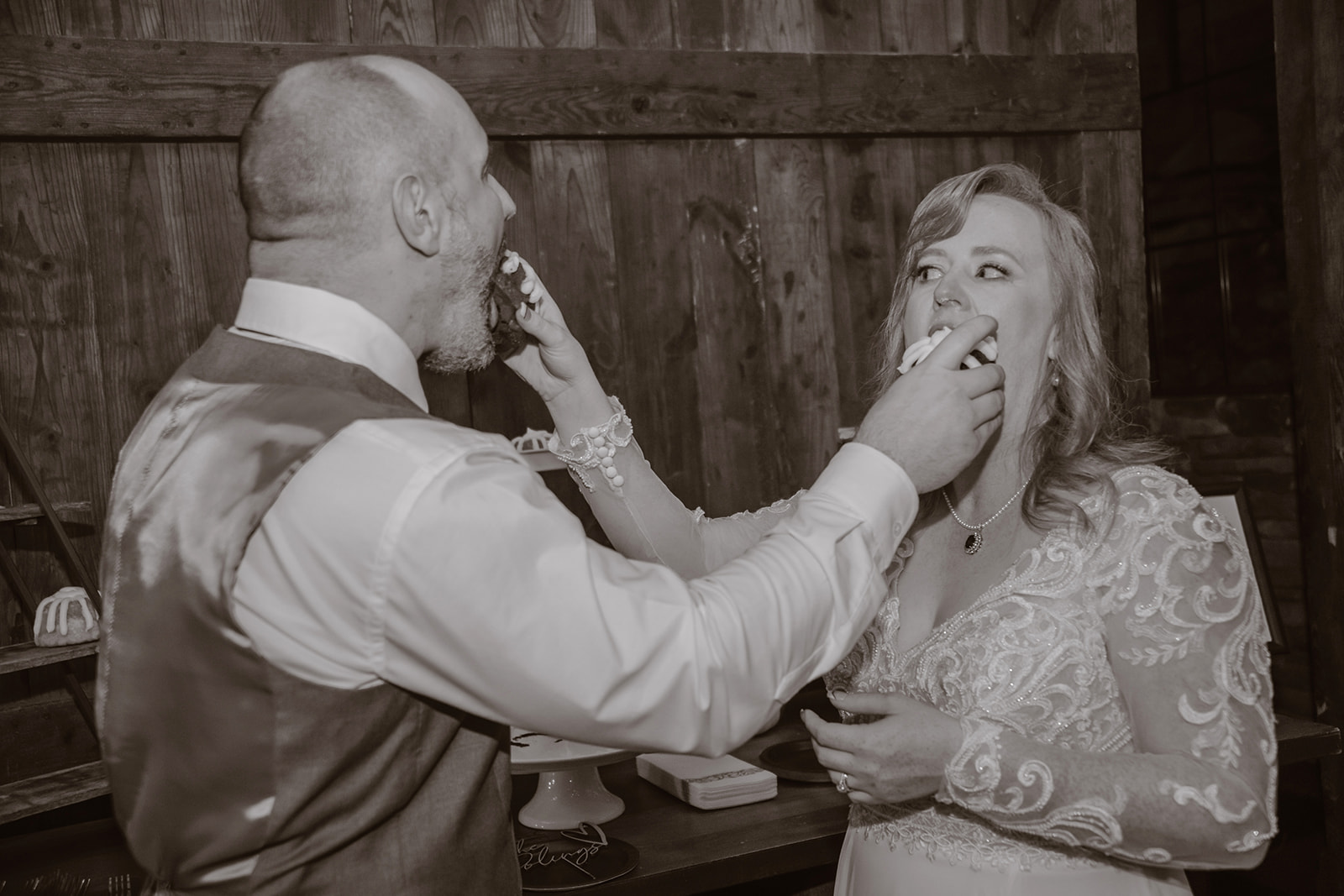 Bride and Groom smashing cake in each other's faces.