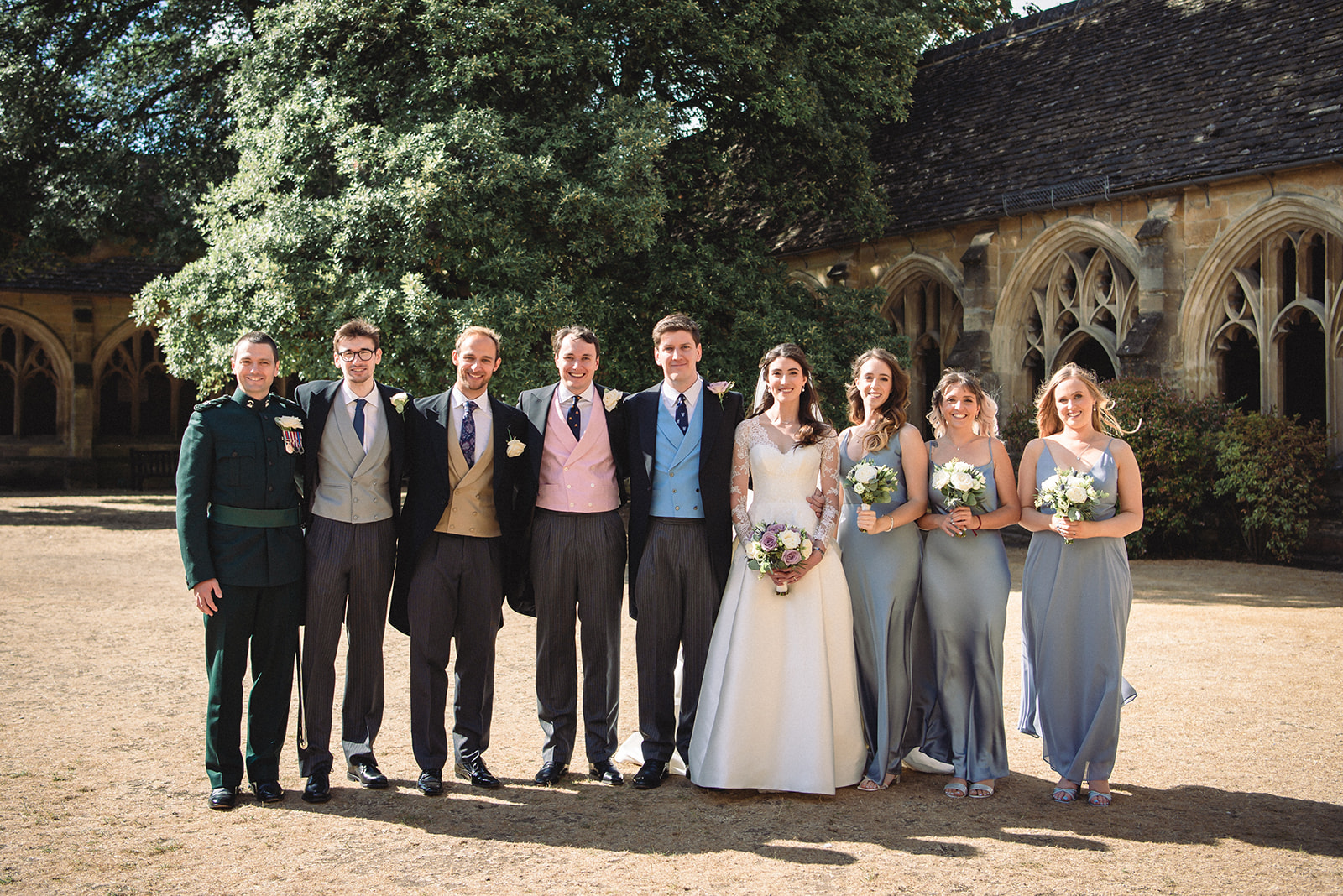 Beautiful portrait of Katherine and Damien with the groom's men and bride's maid outside the New College Chapel