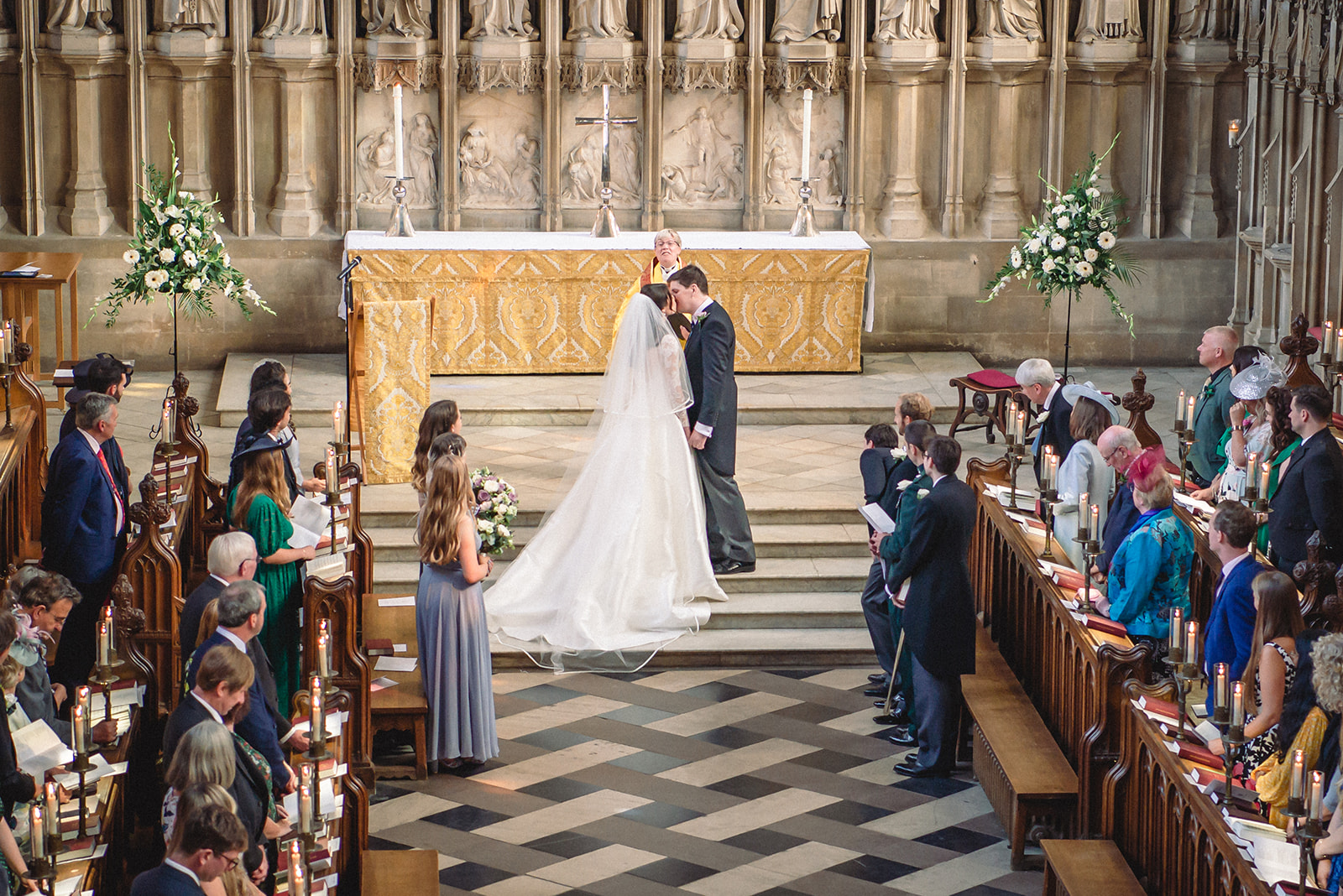 Katherine and Damien kissing during wedding ceremony at the New College Chapel