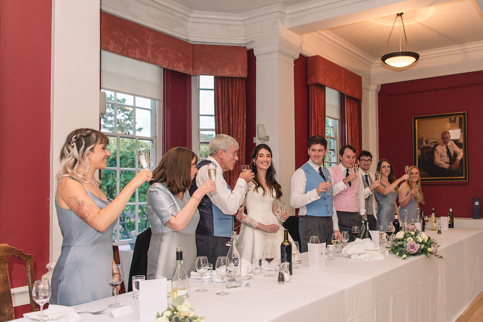 Katherine and Damien toast during wedding reception at the St. Hugh's College Dining Hall