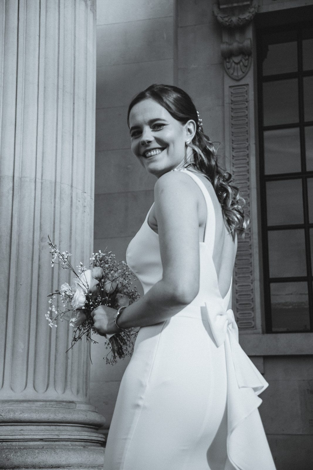 bride's beautiful portrait on the steps of Marylebone Town Hall