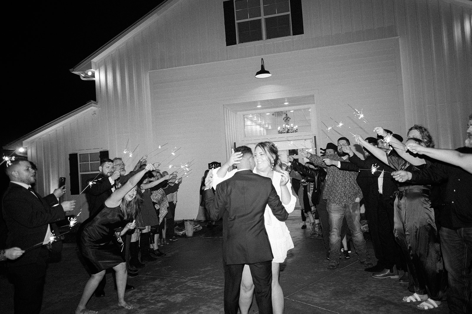 black and white photo of the bride and groom during their sparkler exit