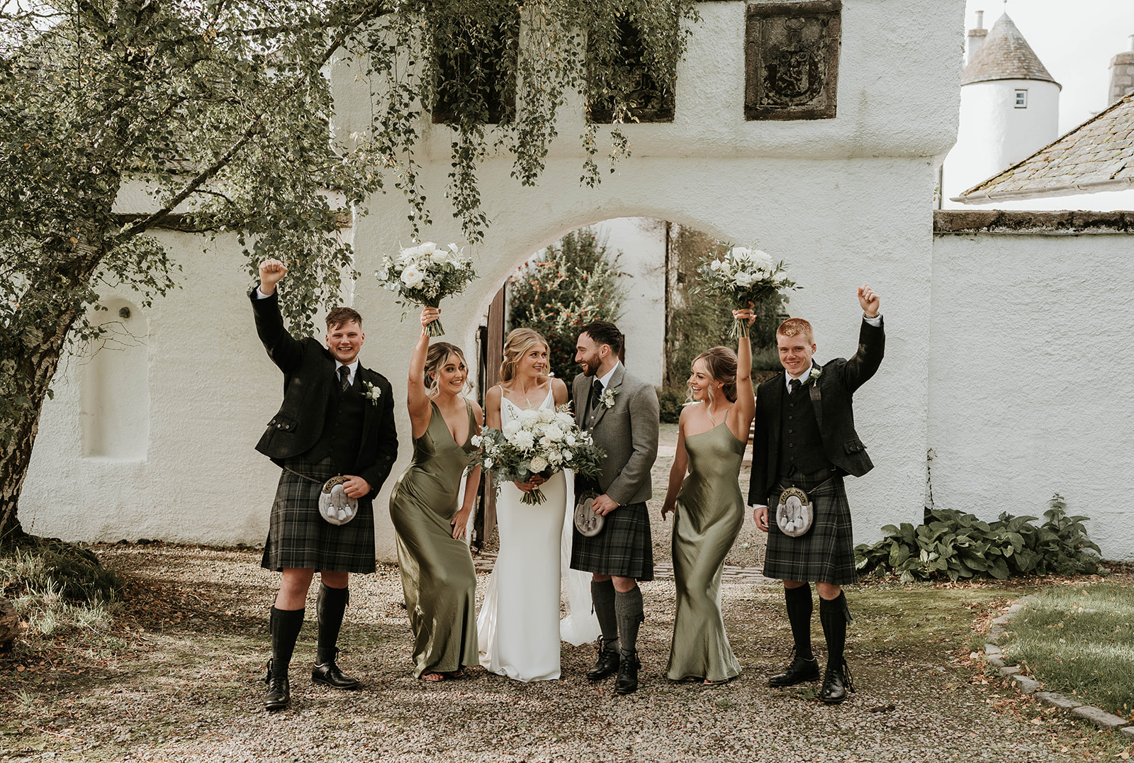 A BRIDAL PARTY CELEBRATING A WEDDING AT LOGIE COUNTRY HOUSE