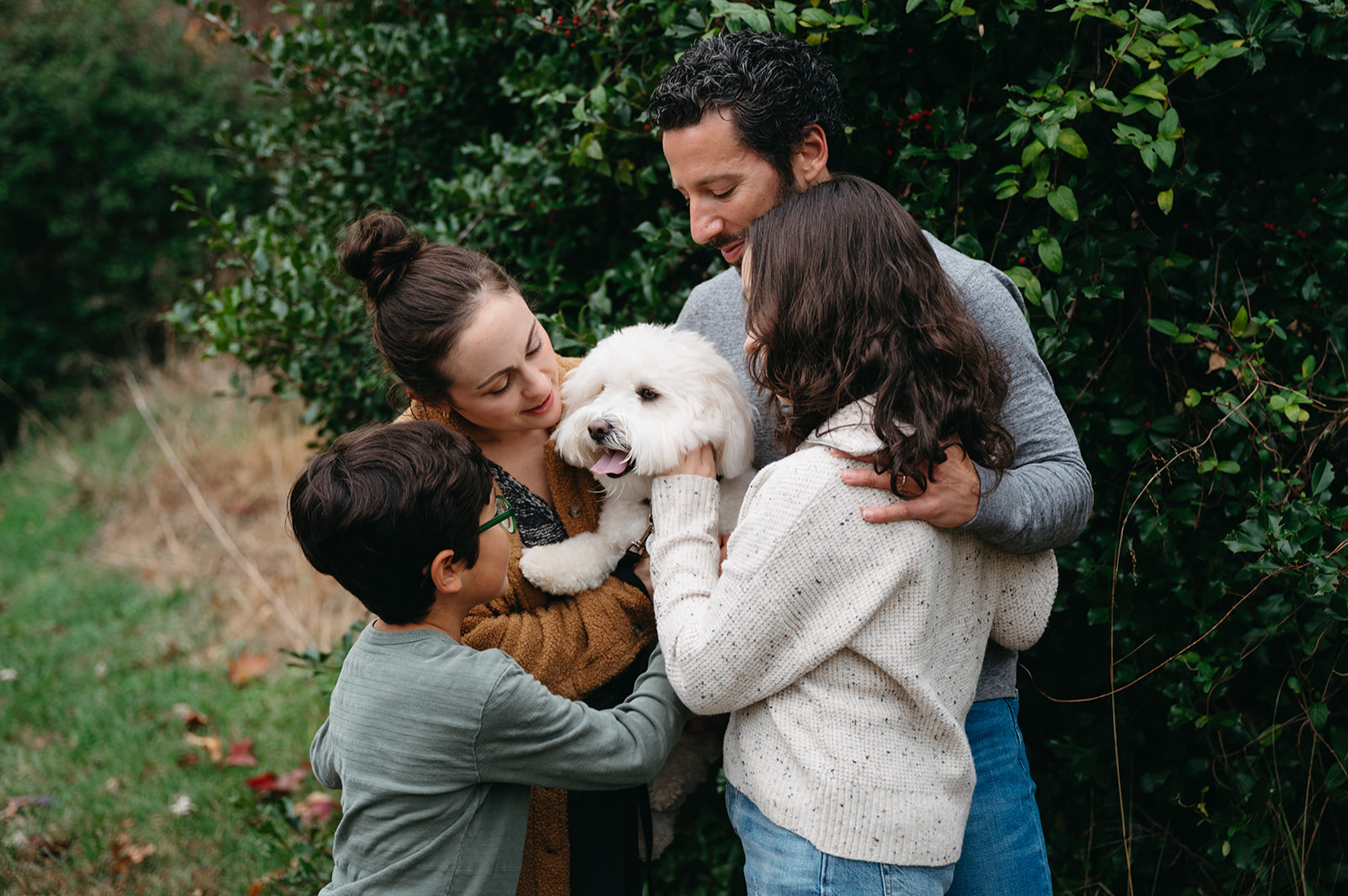 Family of 4 loving on their dog 