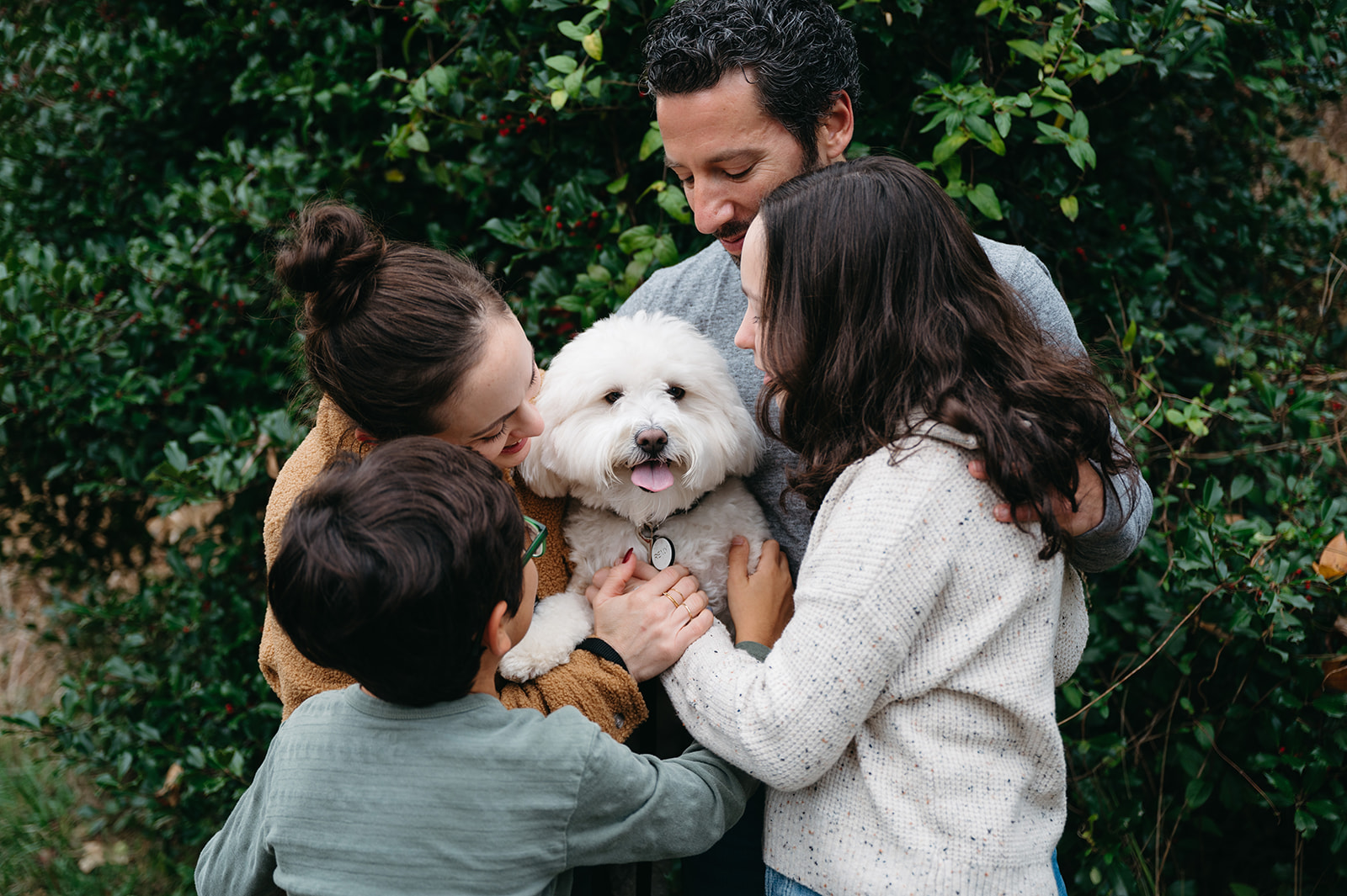 Family of 4 loving on their dog 