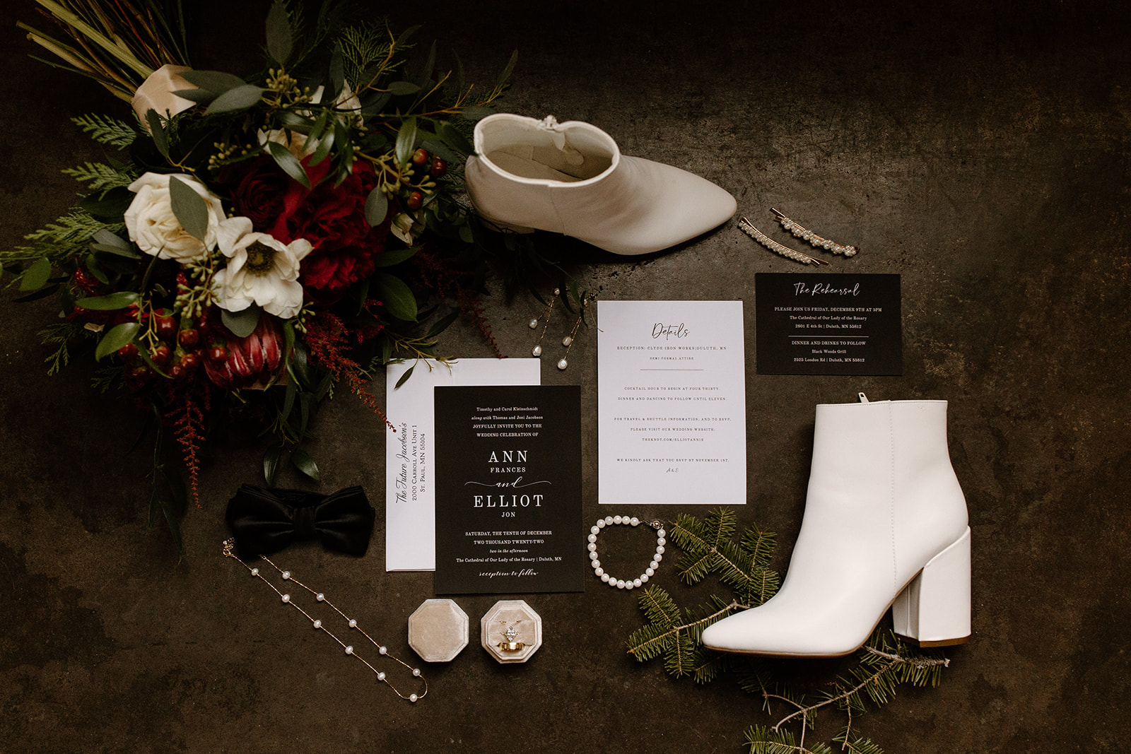 flat lay of wedding invitations, jewelry, and shoes