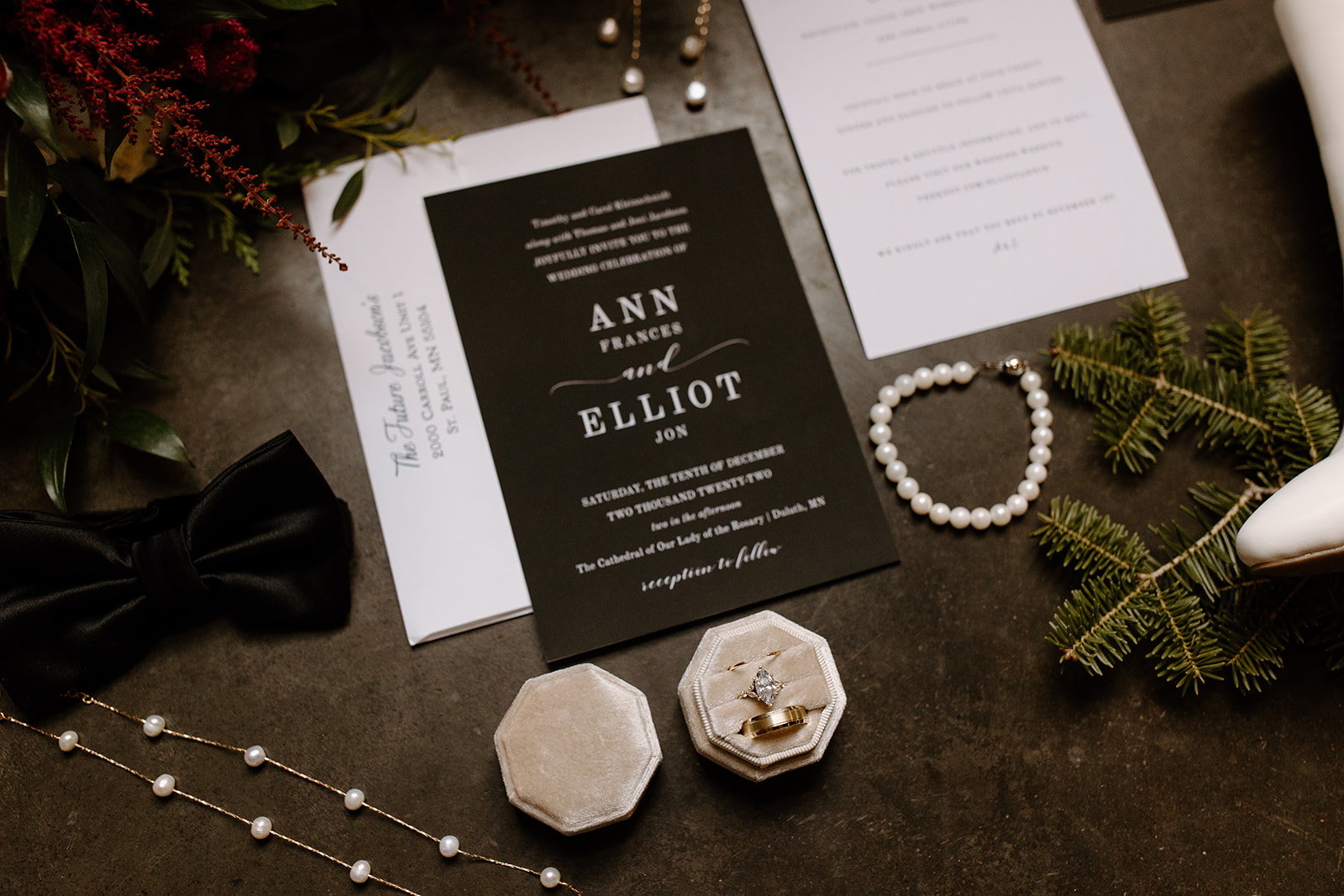 flat lay of wedding invitations, jewelry, and shoes