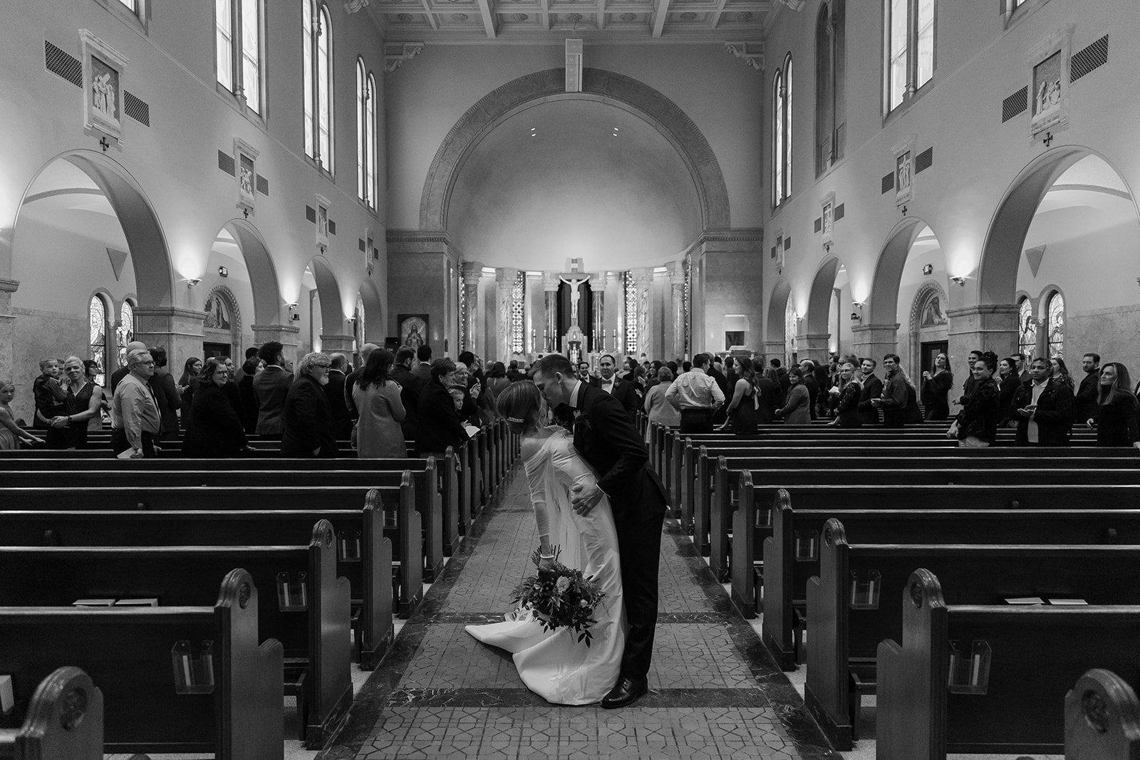 Bride and groom first kiss in a church