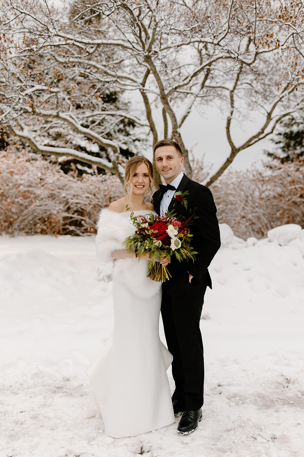 Bride and groom outside in a snowstorm