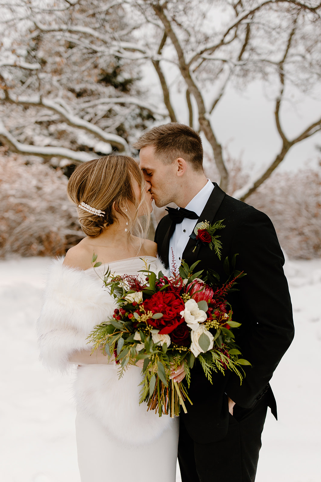 Bride and groom outside in a snowstorm