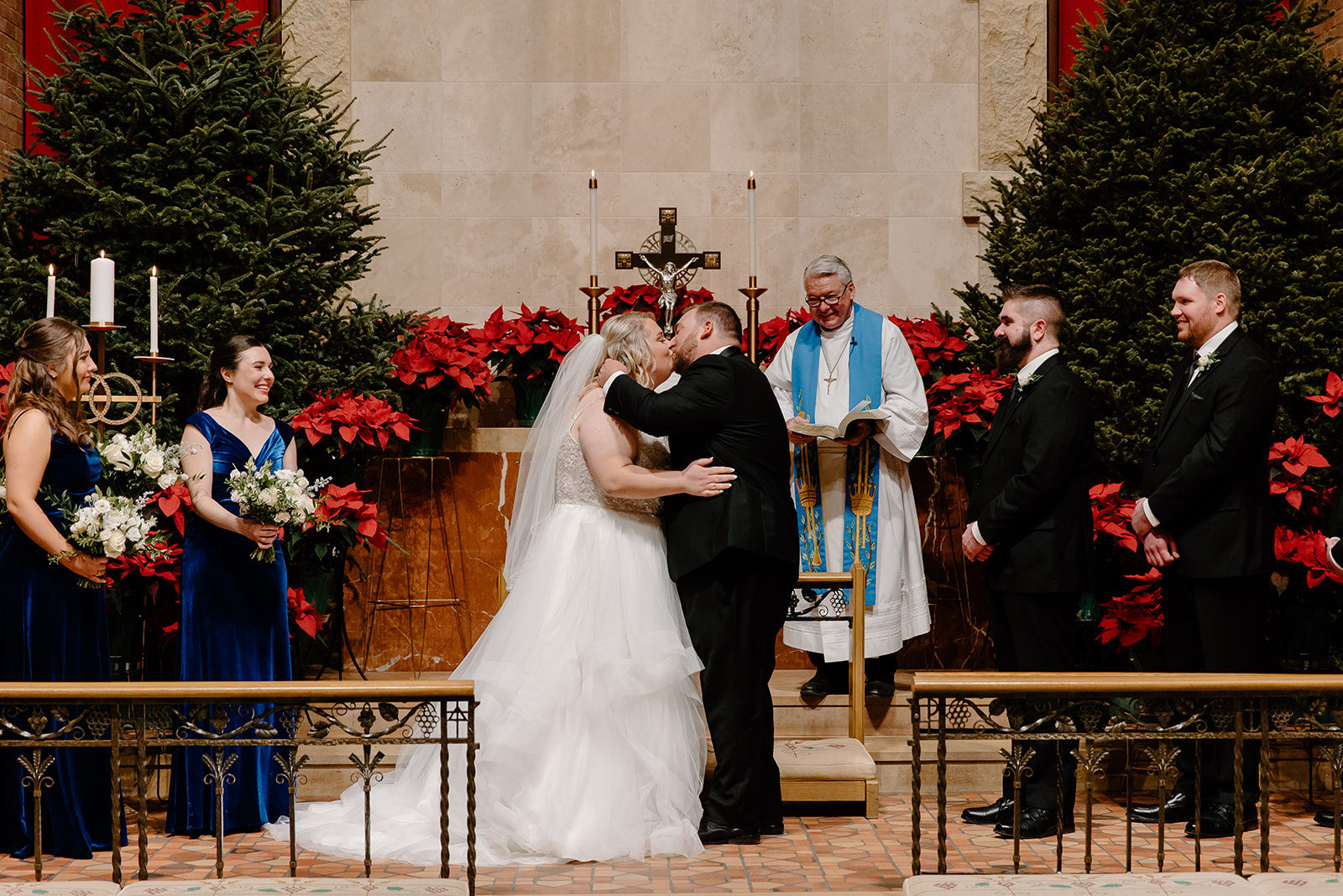 Bride and groom kiss in church during wedding ceremony