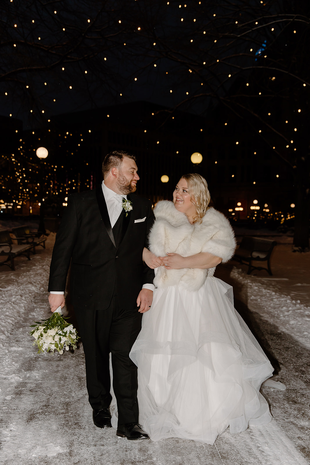 Bride and groom walking in a snowstorm