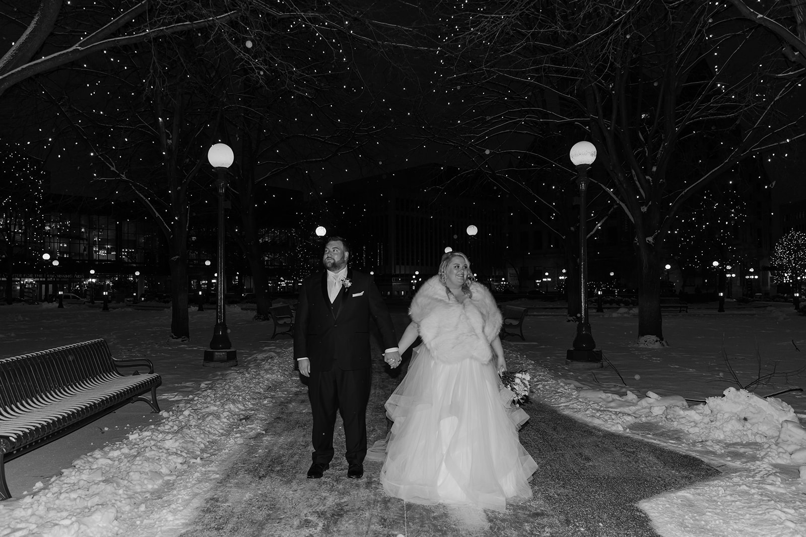 Bride and groom walking in a snowstorm