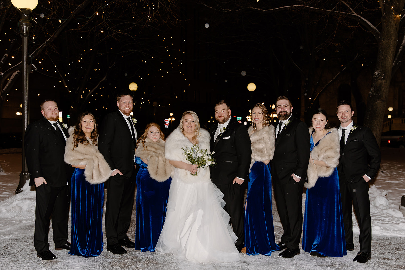 Bride and groom and their wedding party in a snowstorm