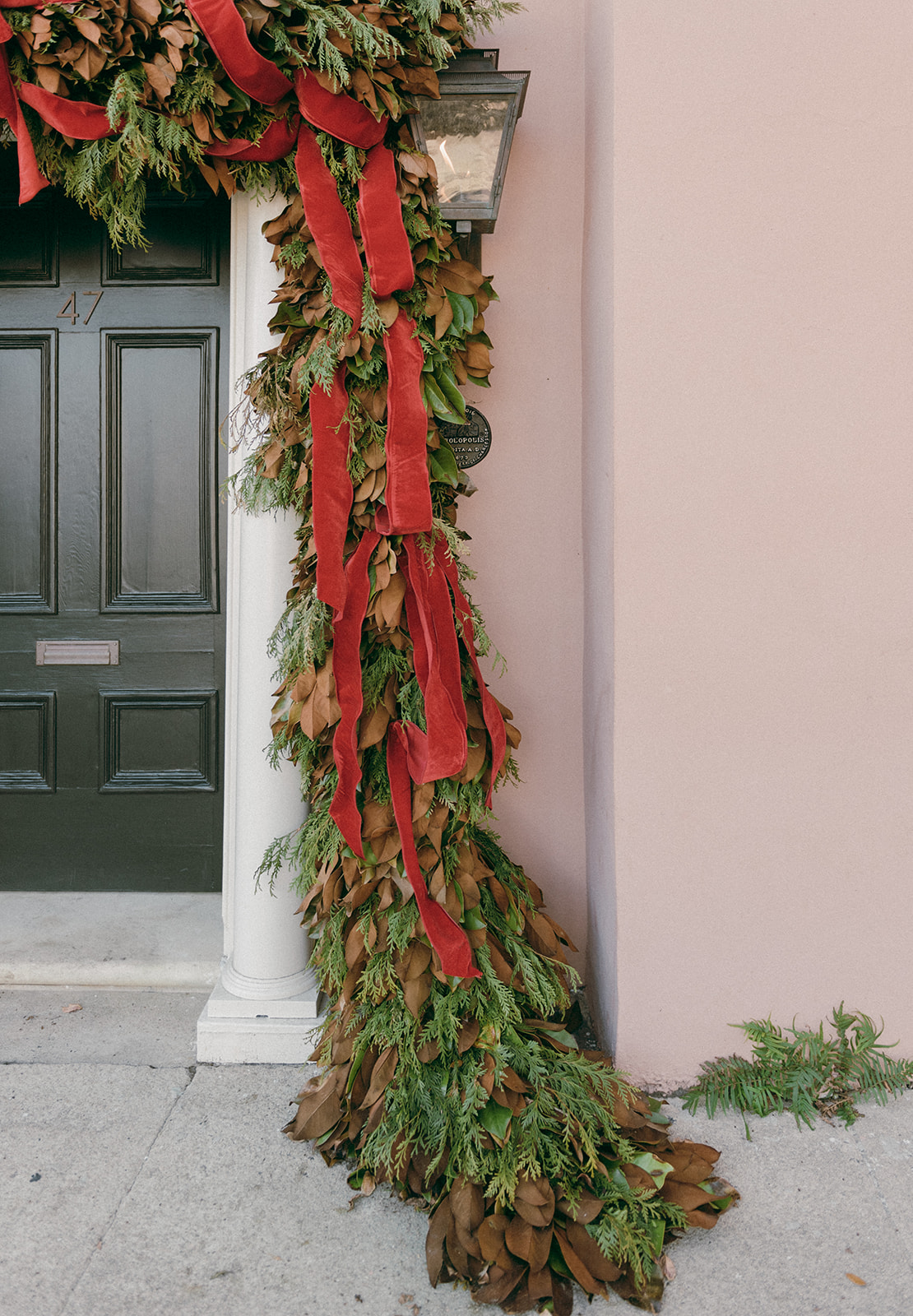 Magnolia garland adorns the door of a home in Charleston