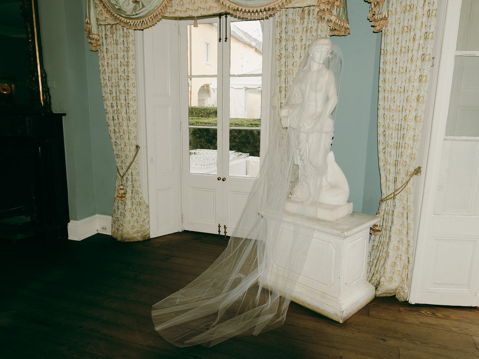 The bride's veil adorns a statue