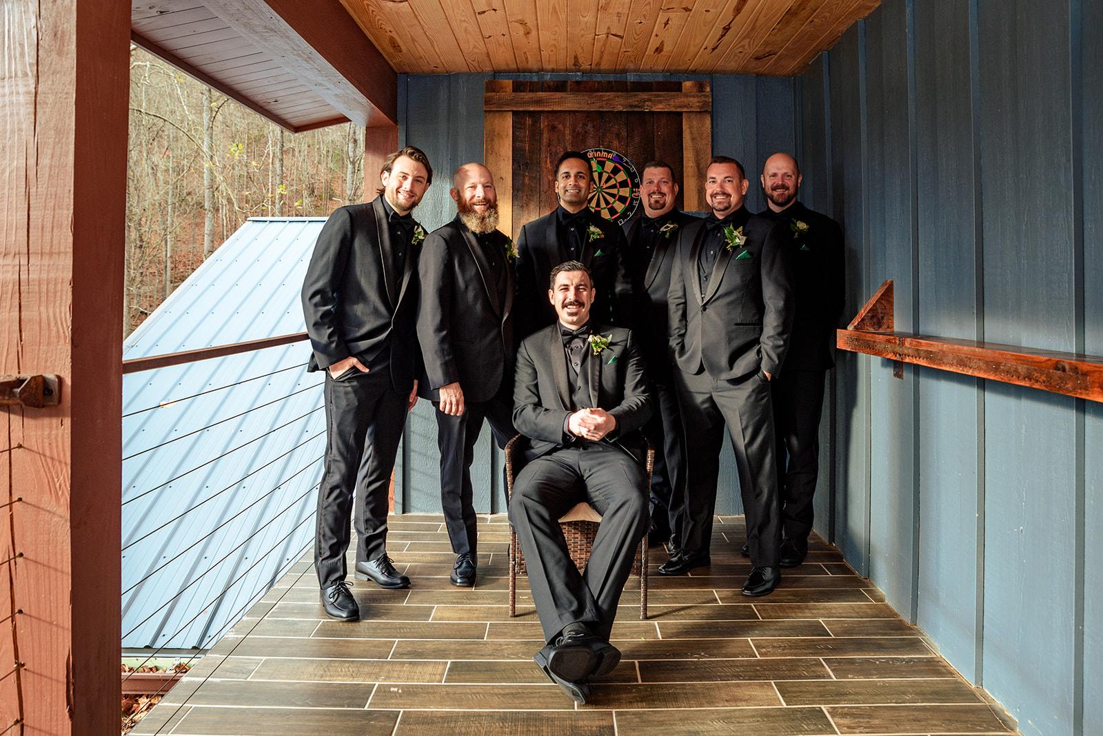 Groom and groomsmen, sitting on balcony of the grooms quarters at the parker mill