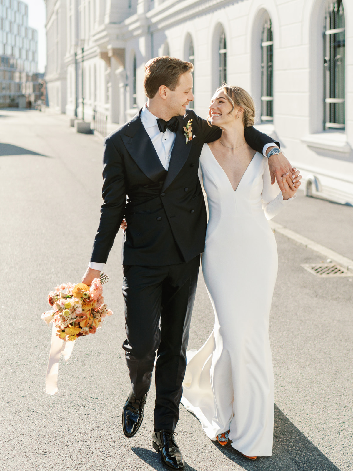 Chic and modern couple just got married in Oslo city wedding bride wearing a sleek gown and orange manolo blahniks 